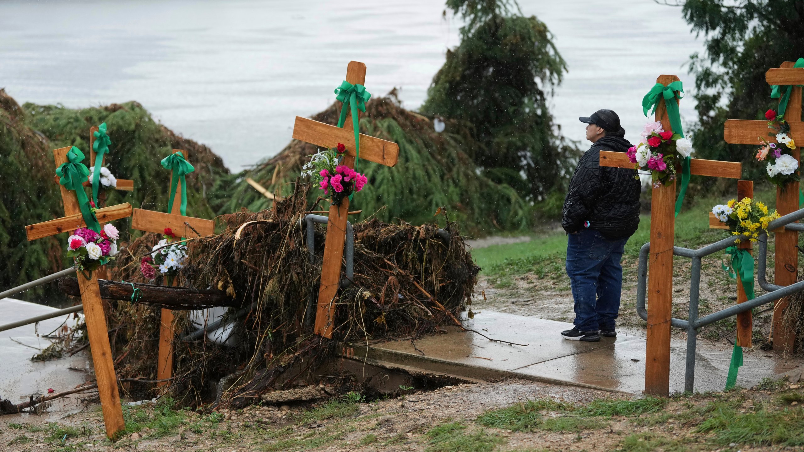 Woman makes a make-shift memorial for flood victims