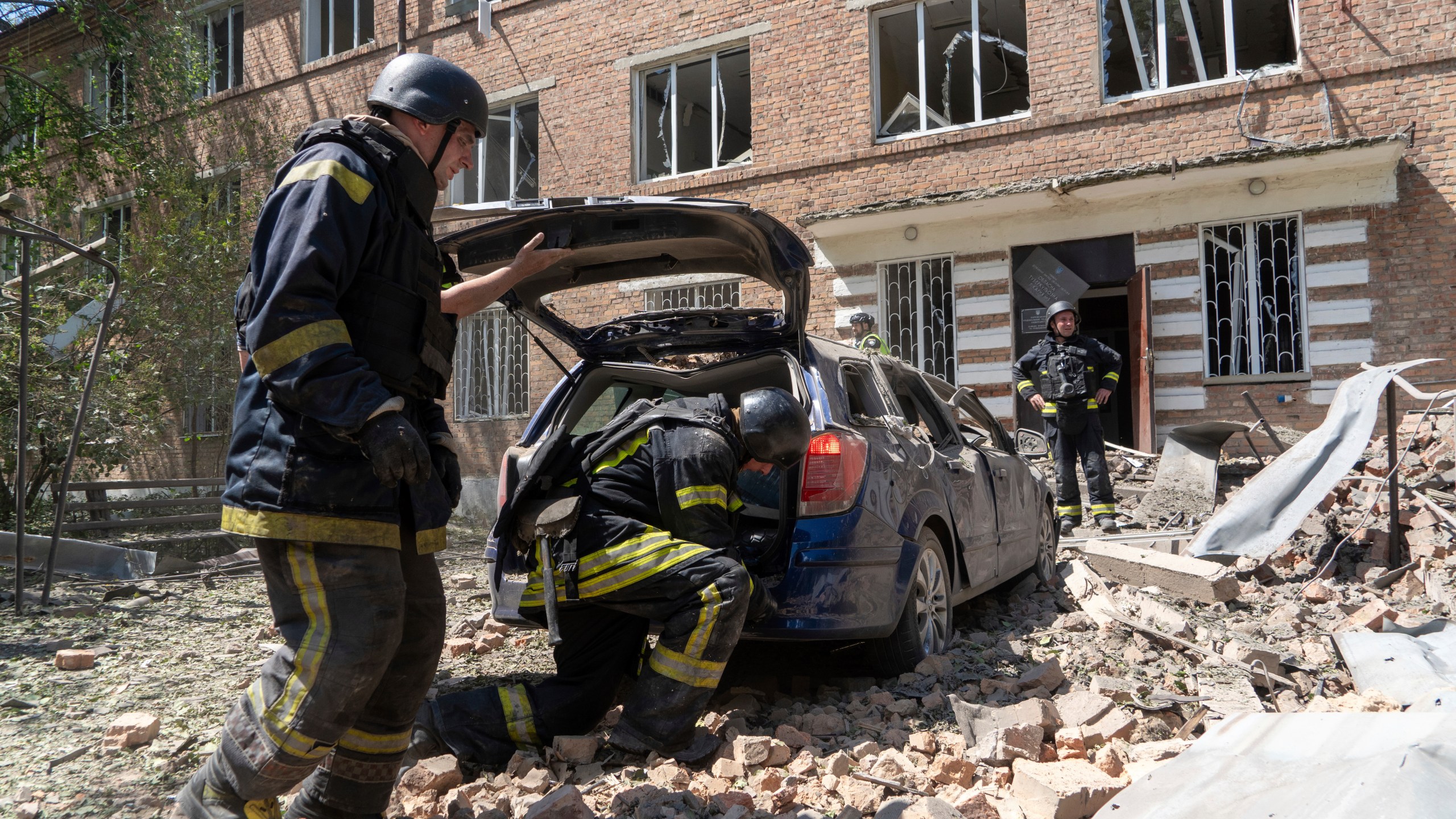 Rescuers work at a damaged city hospital that was hit by a Russian guided air bomb in Kharkiv, Ukraine, Friday, July 25, 2025. (AP Photo/Andrii Marienko)