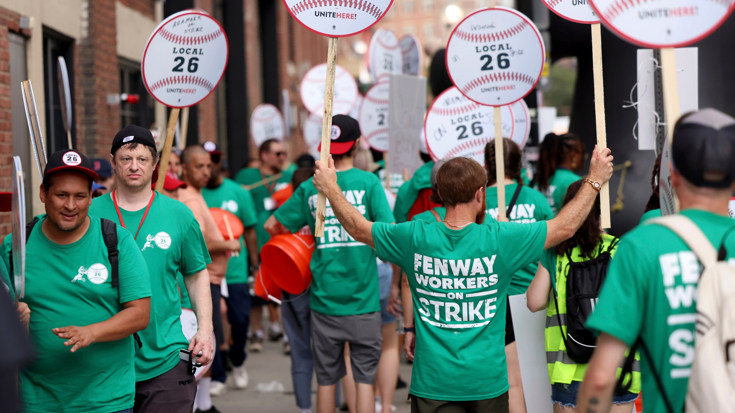 Concession workers from Fenway Park picket outside the ballpark Friday, July 25, 2025, in Boston before a baseball game between the Boston Red Sox and the Los Angeles Dodgers. (AP Photo/Mark Stockwell)