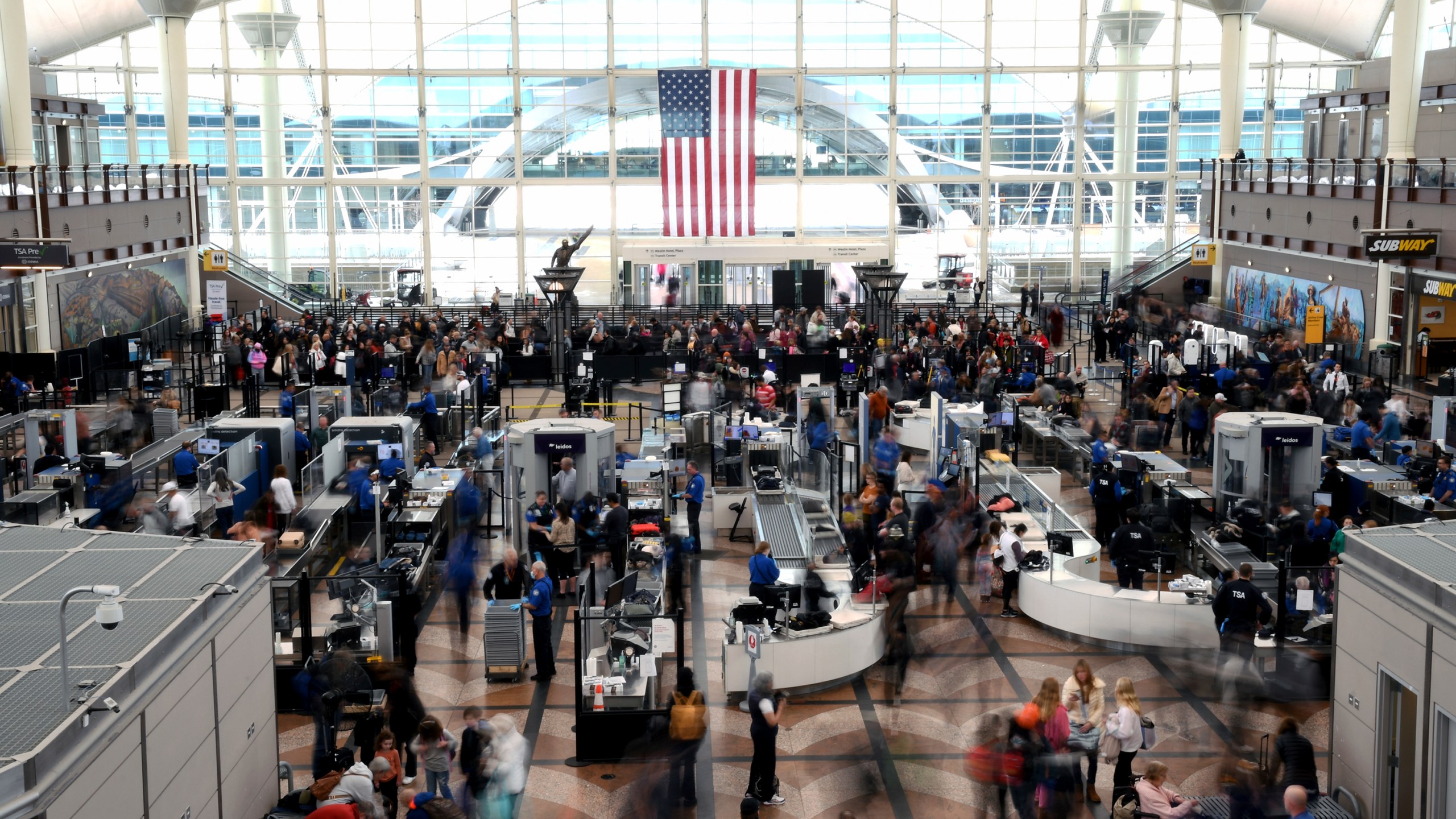 FILE - Passengers wait in a security line at Denver International Airport on Feb. 22, 2023. (AP Photo/Thomas Peipert, File)