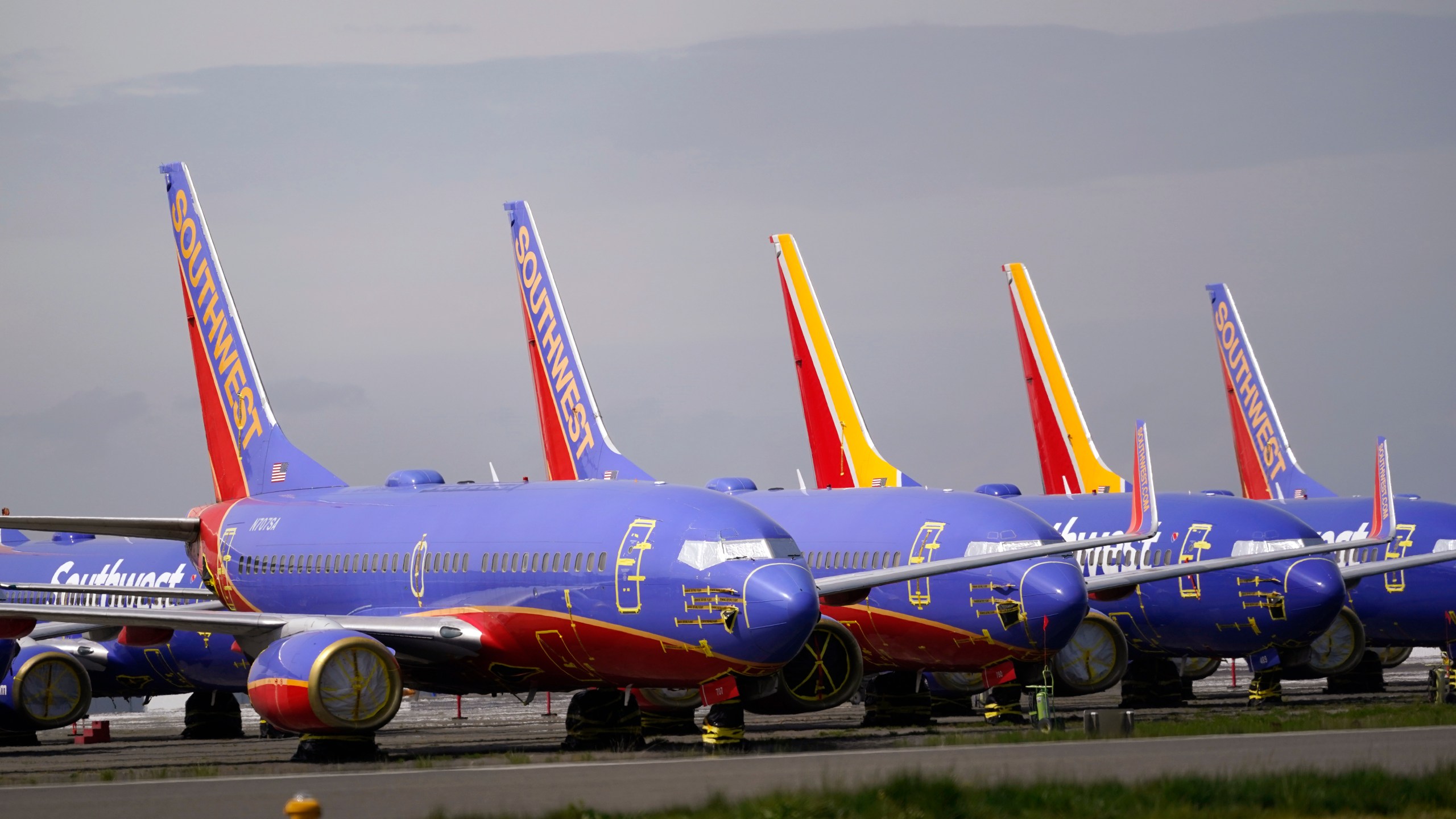 FILE - A line of Southwest Air Boeing 737 jets are parked near the company's production plant while being stored at Paine Field Friday, April 23, 2021, in Everett, Wash. (AP Photo/Elaine Thompson, File)