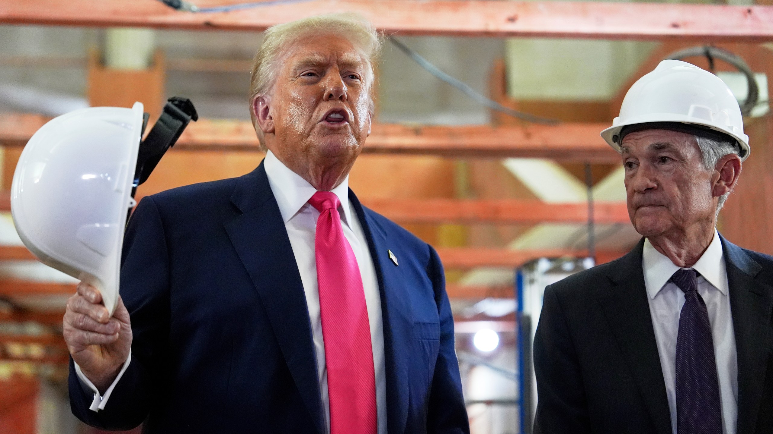 President Donald Trump speaks as Federal Reserve Chairman Jerome Powell listens during a visit to the Federal Reserve, Thursday, July 24, 2025, in Washington. (AP Photo/Julia Demaree Nikhinson)