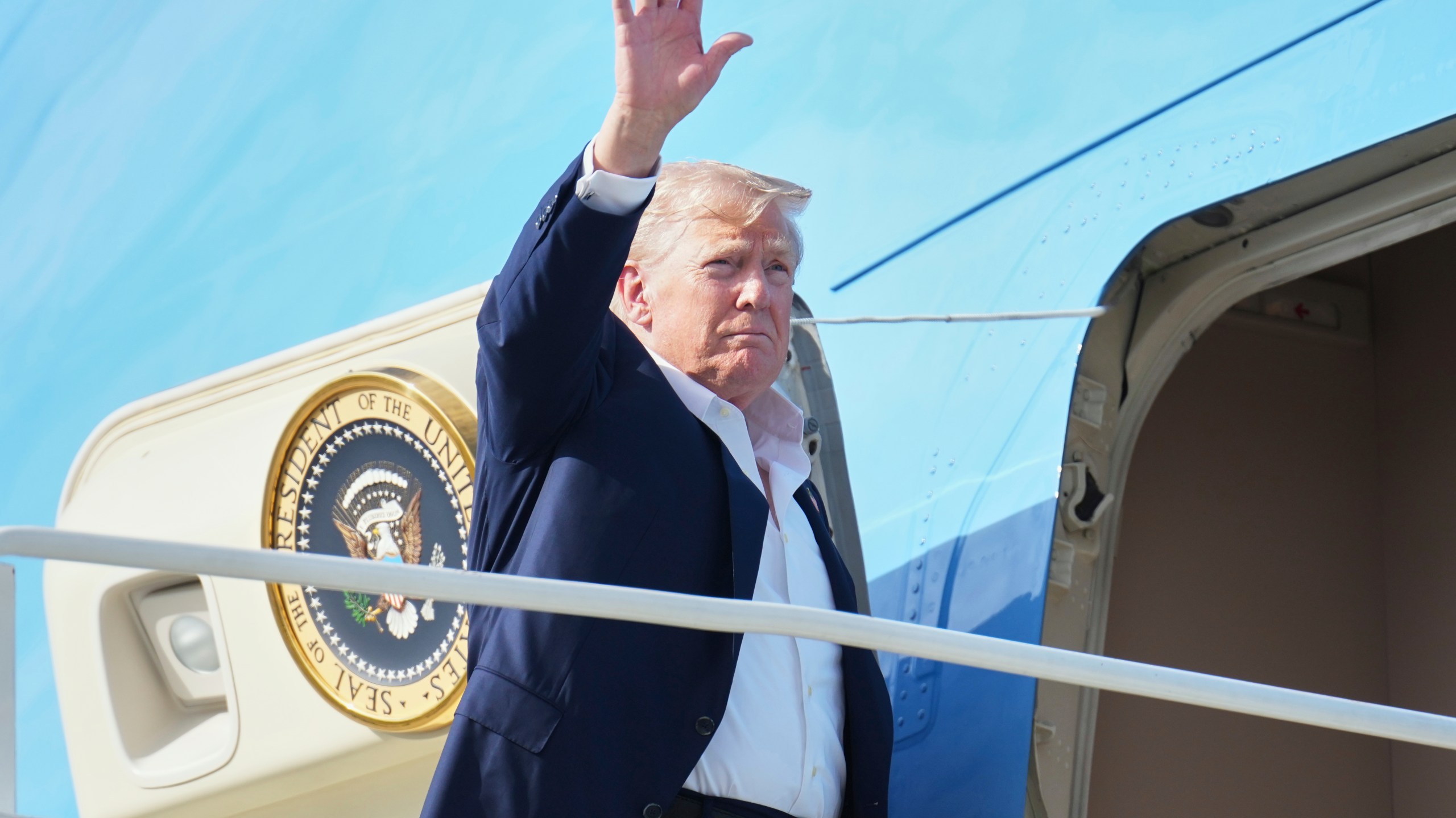 President Donald Trump waves as he boards Air Force One, Tuesday, July 29, 2025, at Royal Air Force Lossiemouth en route to return to Washington. (AP Photo/Jacquelyn Martin)