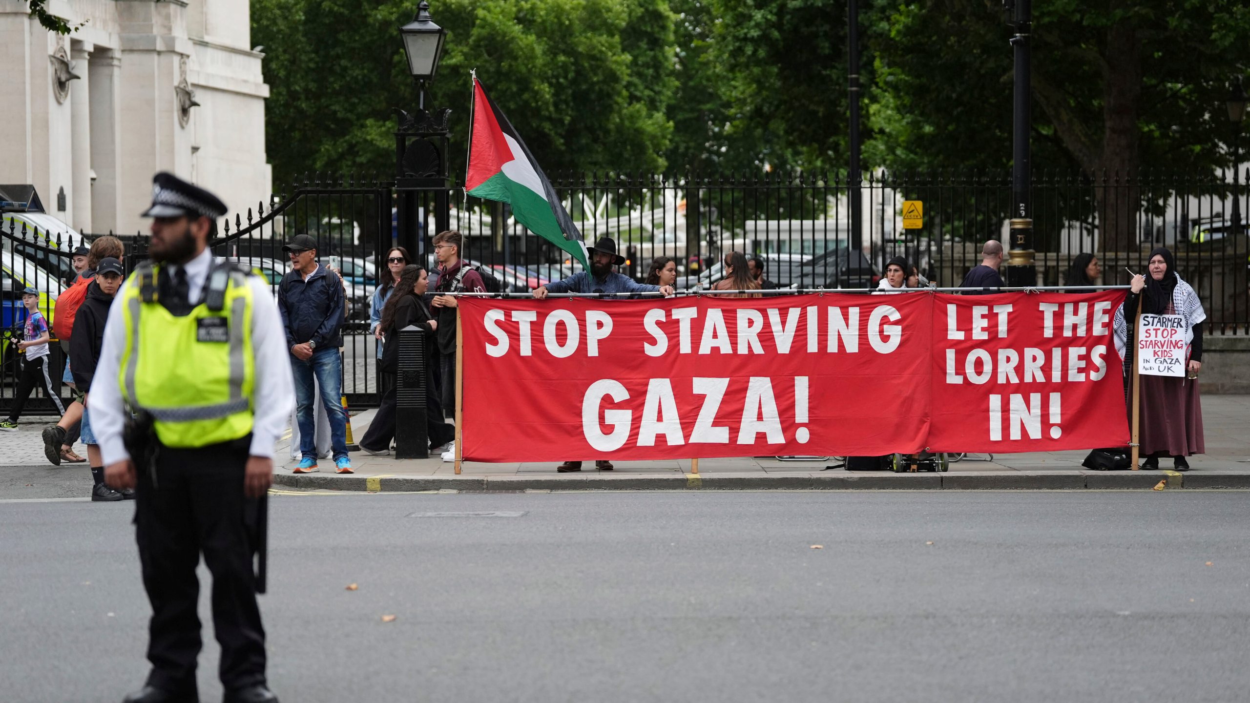 People take part in a protest outside Downing Street in London, Tuesday July 29, 2025, as Prime Minister Keir Starmer gathered senior ministers for an urgent Cabinet meeting on Gaza. (Jonathan Brady/PA via AP)