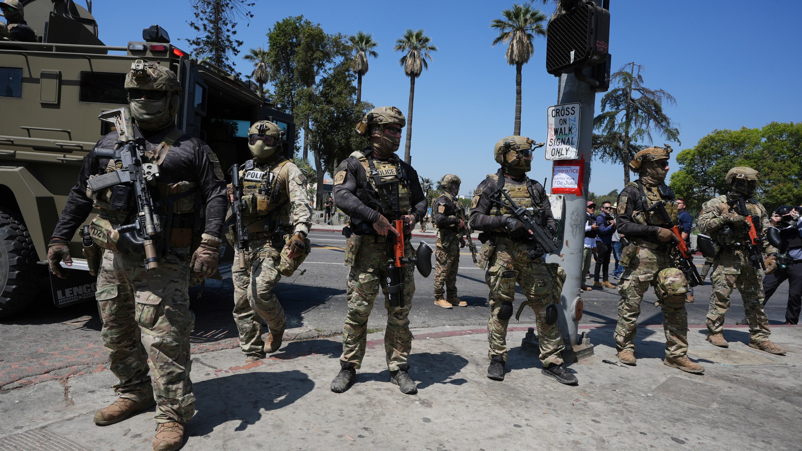 FILE - Federal agents stage at MacArthur Park Monday, July 7, 2025, in Los Angeles. (AP Photo/Damian Dovarganes,File)