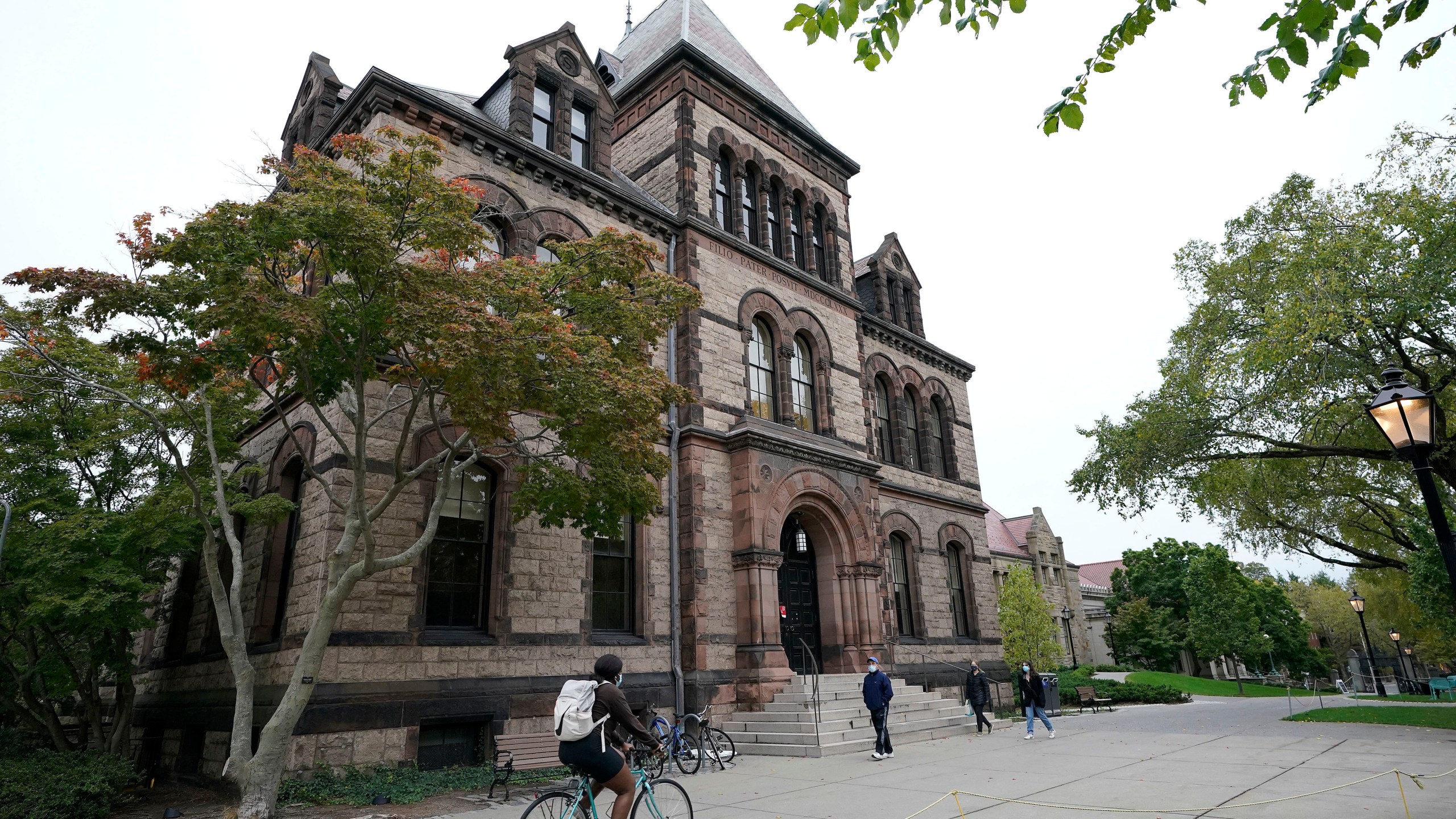 FILE - People traverse Brown University campus in Providence, R.I., Oct. 12, 2020. (AP Photo/Steven Senne, File)