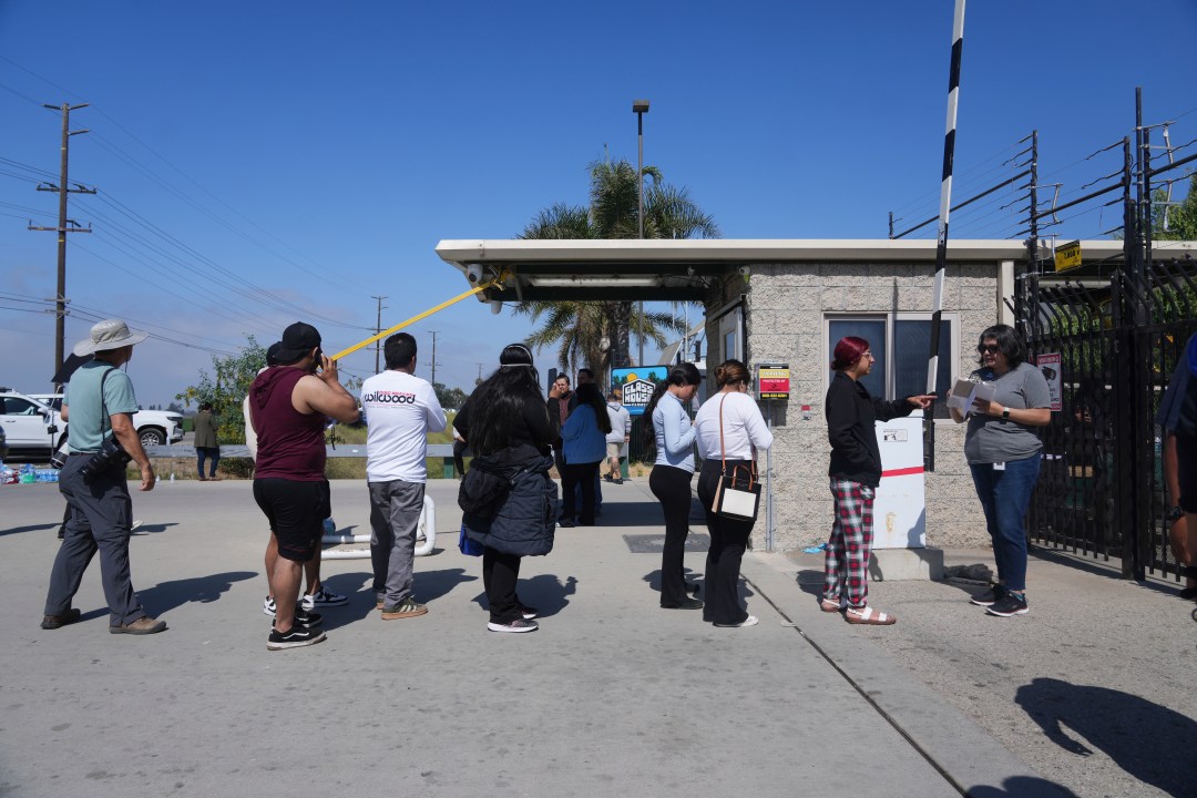 People line out outside of Glass House Farms, a day after an immigration raid on the facility, on Friday, July 11, 2025