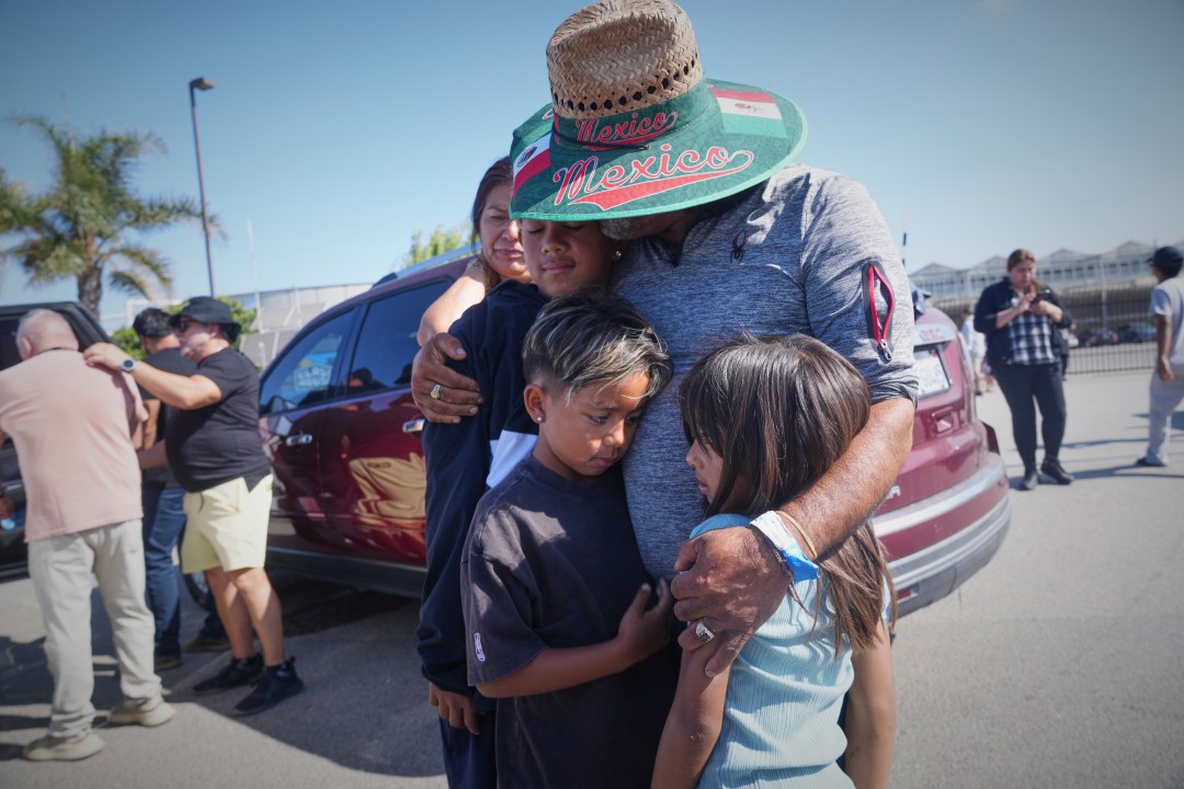 People embrace outside of Glass House Farms, a day after an immigration raid on the facility, on Friday, July 11, 2025, in Camarillo, Calif