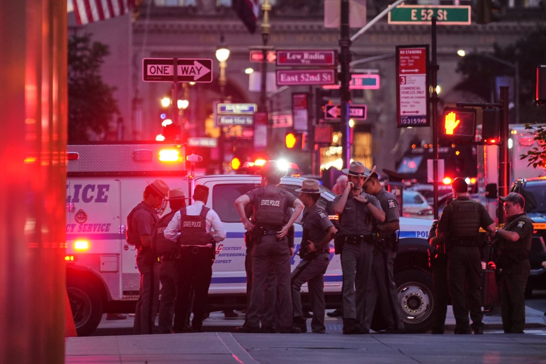 New York State Police troopers gather on 52nd Street outside a Manhattan office building