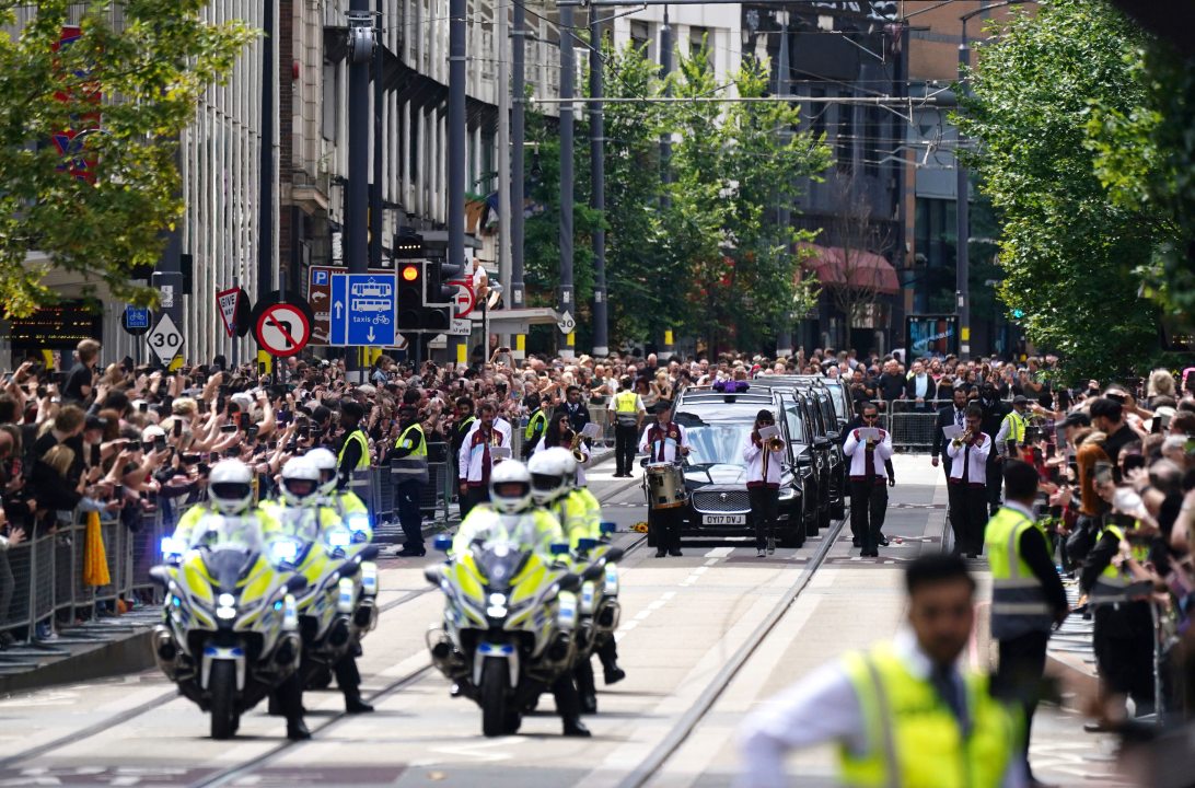 The funeral cortege of Black Sabbath frontman Ozzy Osbourne travels along Broad Street during his funeral procession, in Birmingham, England, Wednesday July 30, 2025. (Jacob King/PA via AP)