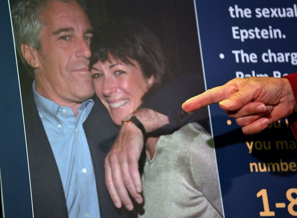 someone pointing to a photo of epstein and maxwell embracing