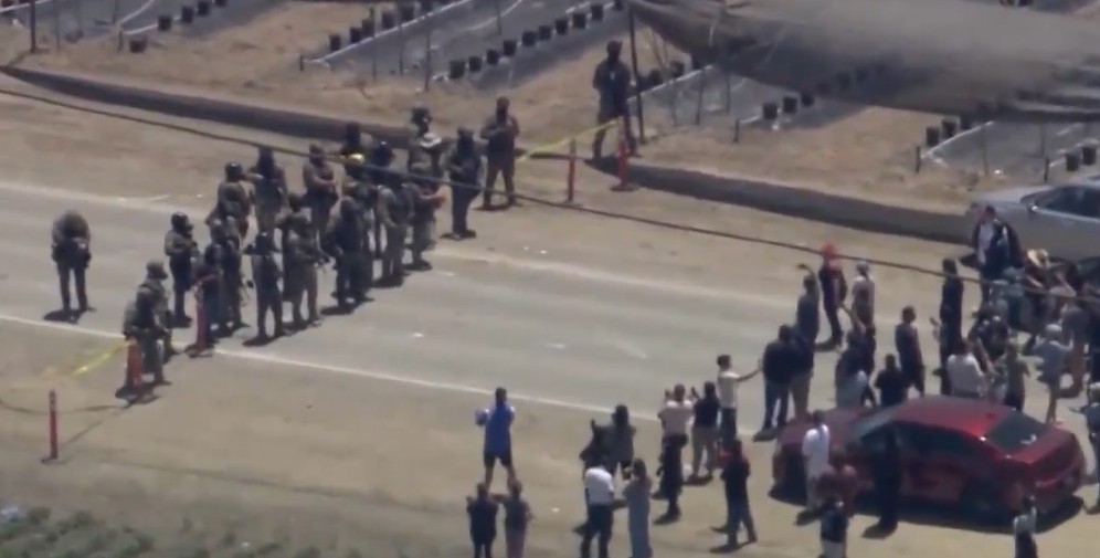 Protesters clash with officials during raid