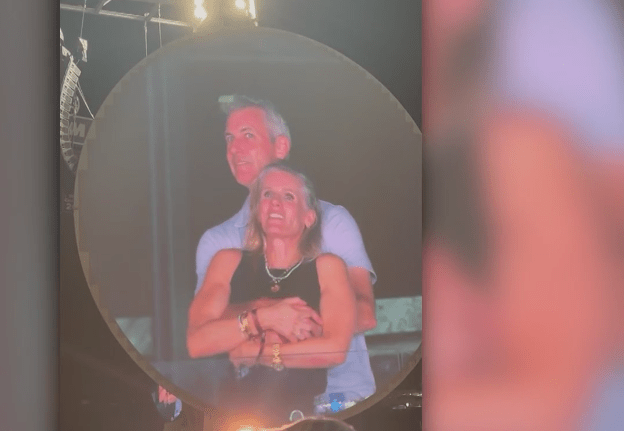 A screenshot of a "kiss cam" video showing Astronomer CEO Andy Byron embracing a woman at a Coldplay concert.