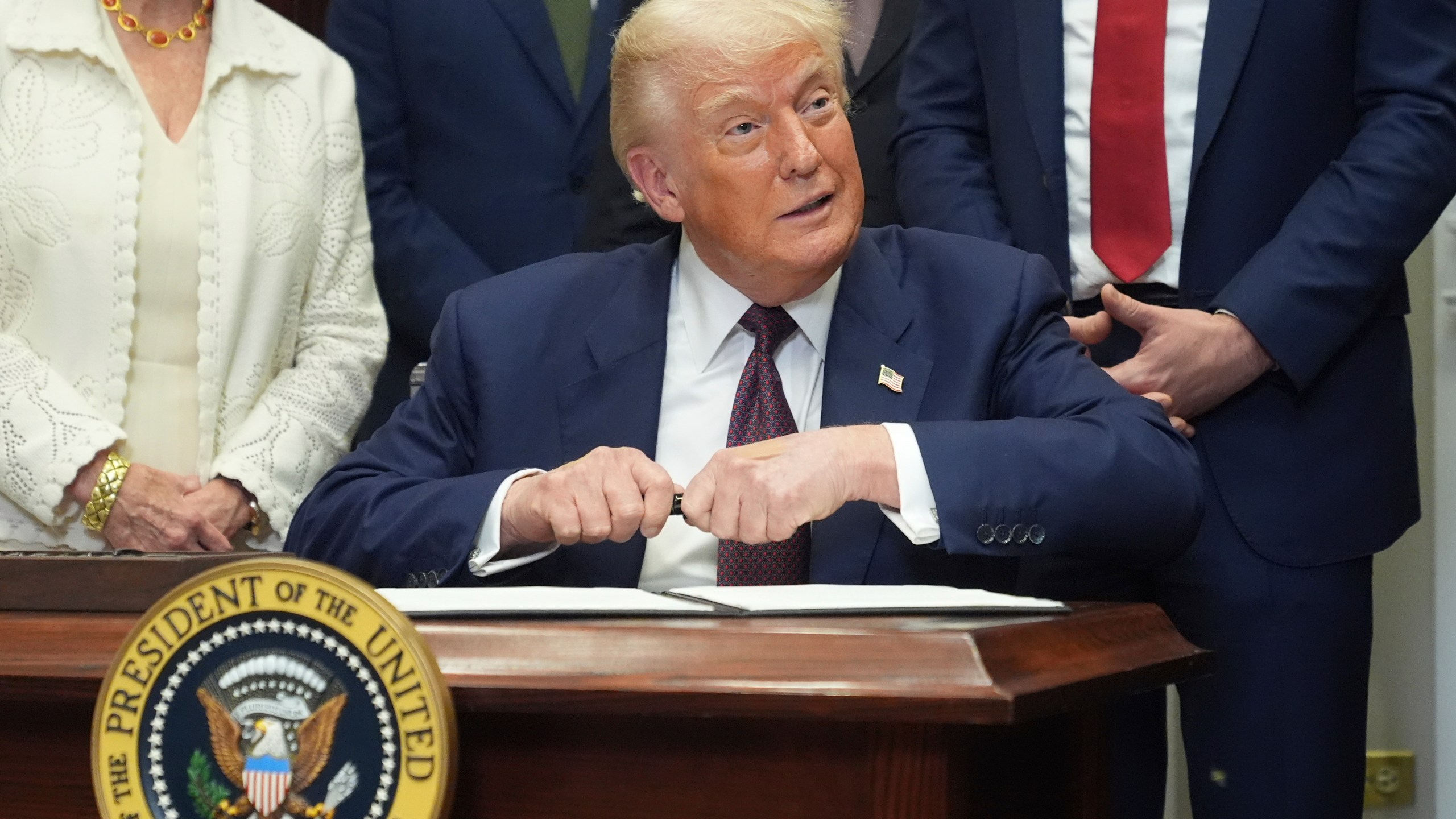 President Donald Trump signs an executive order restarting the Presidential Fitness Test in public schools, Thursday, July 31, 2025, in the Roosevelt Room of the White House in Washington. (AP Photo/Jacquelyn Martin)