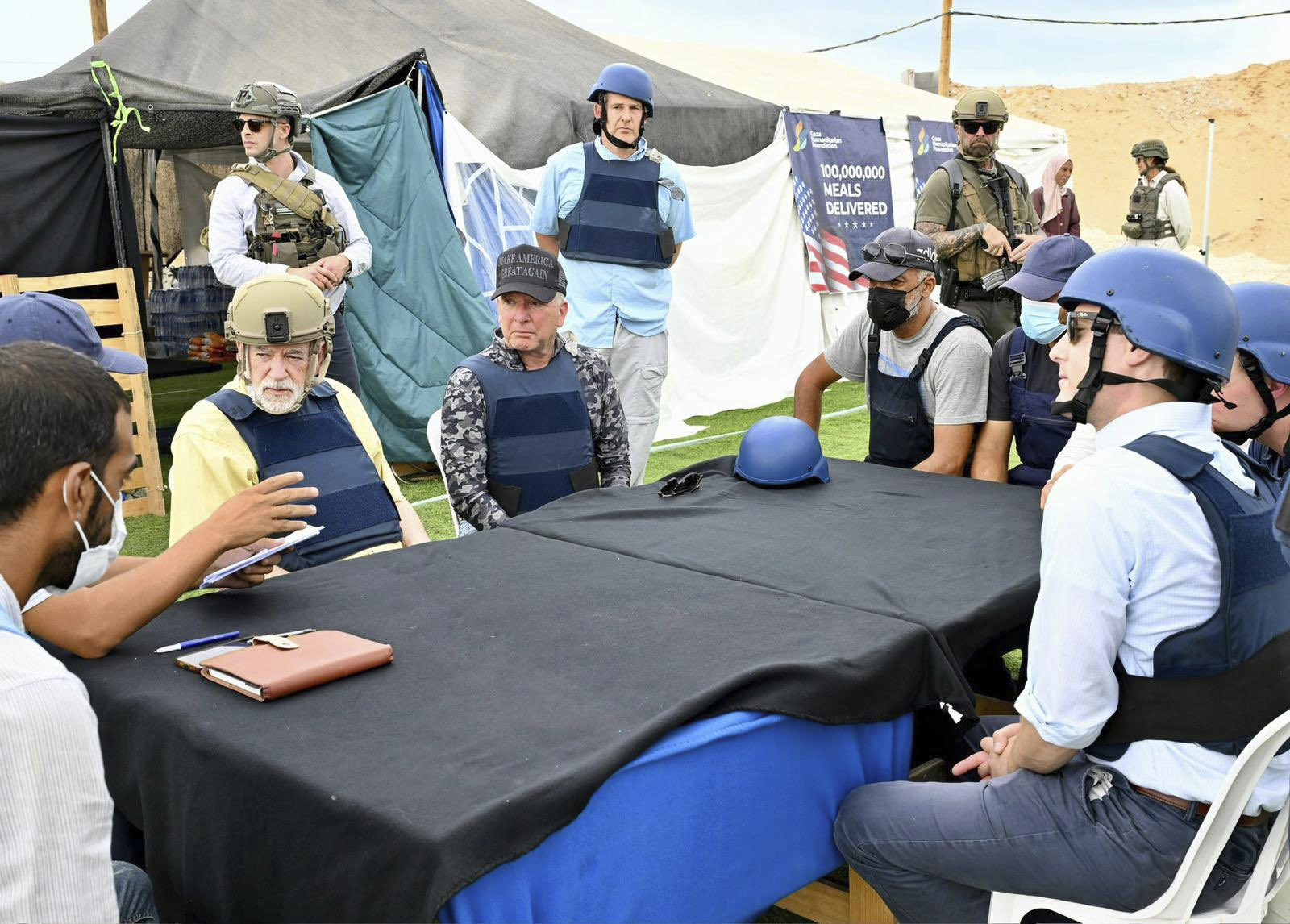 This handout photo from US Embassy Jerusalem shows White House special envoy Steve Witkoff, center, and US Ambassador to Israel Mike Huckabee, center left, visiting a food distribution site run by the Gaza Humanitarian Foundation, a U.S.-backed organization approved by Israel, in the Gaza Strip, Friday, Aug. 1, 2025. (David Azaguri/US Embassy Jerusalem via AP)