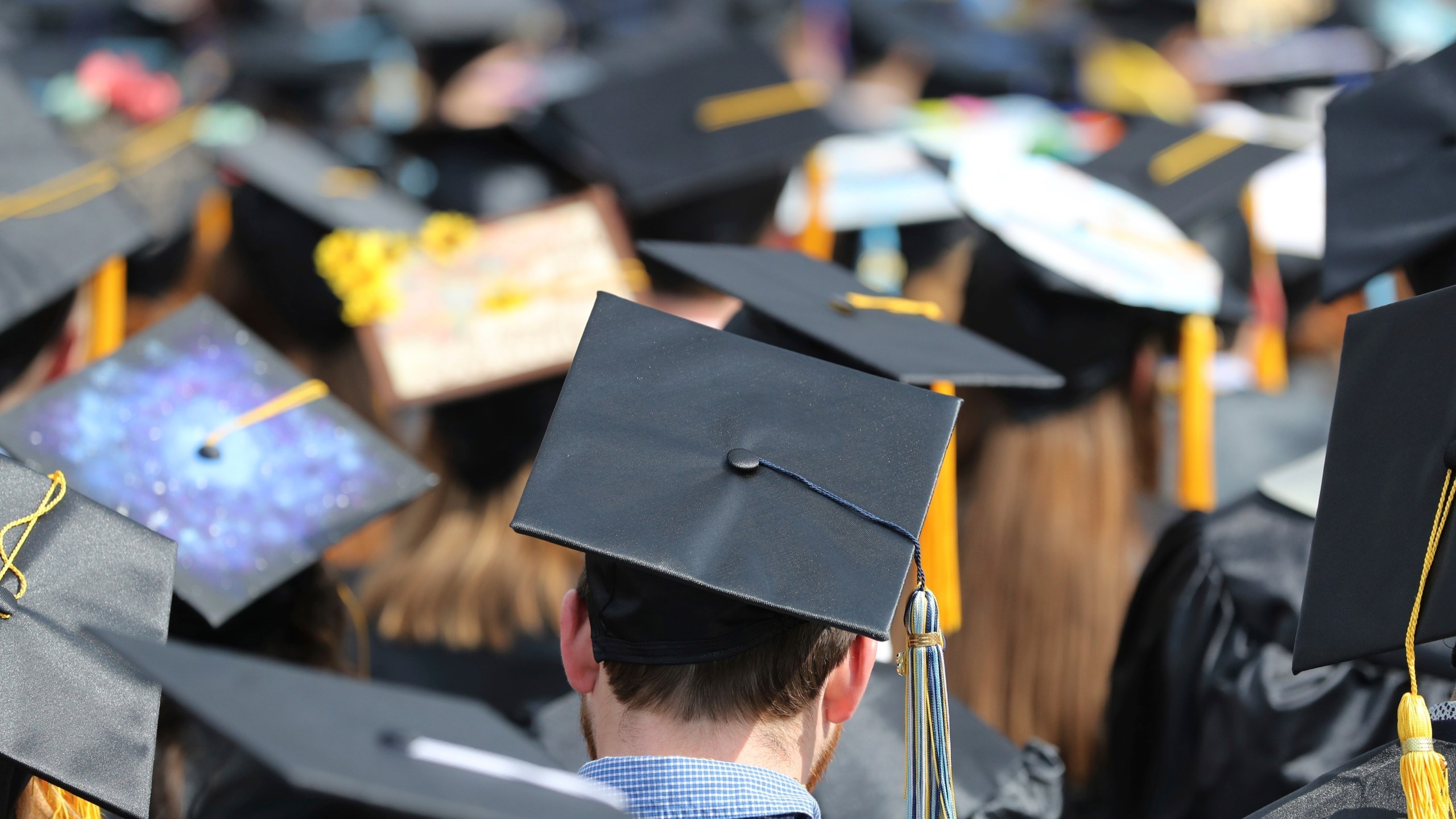 FILE - In this May 5, 2018, file photo, graduates at the University of Toledo commencement ceremony in Toledo, Ohio. (AP Photo/Carlos Osorio, File)