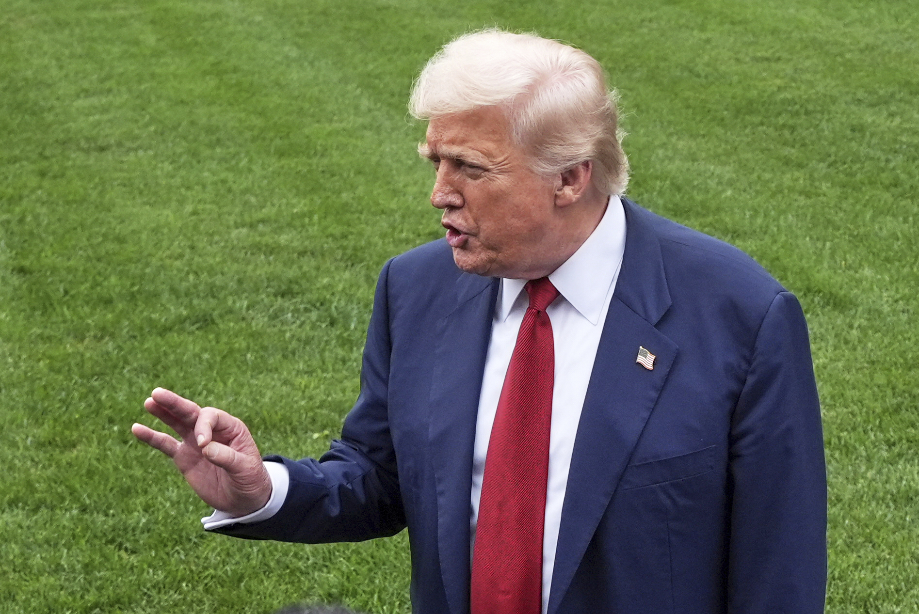 President Donald Trump speaks with reporters before walking across the South Lawn of the White House to board Marine One en route to Joint Base Andrews, Md., Friday, Aug. 1, 2025, in Washington. (AP Photo/Jacquelyn Martin)