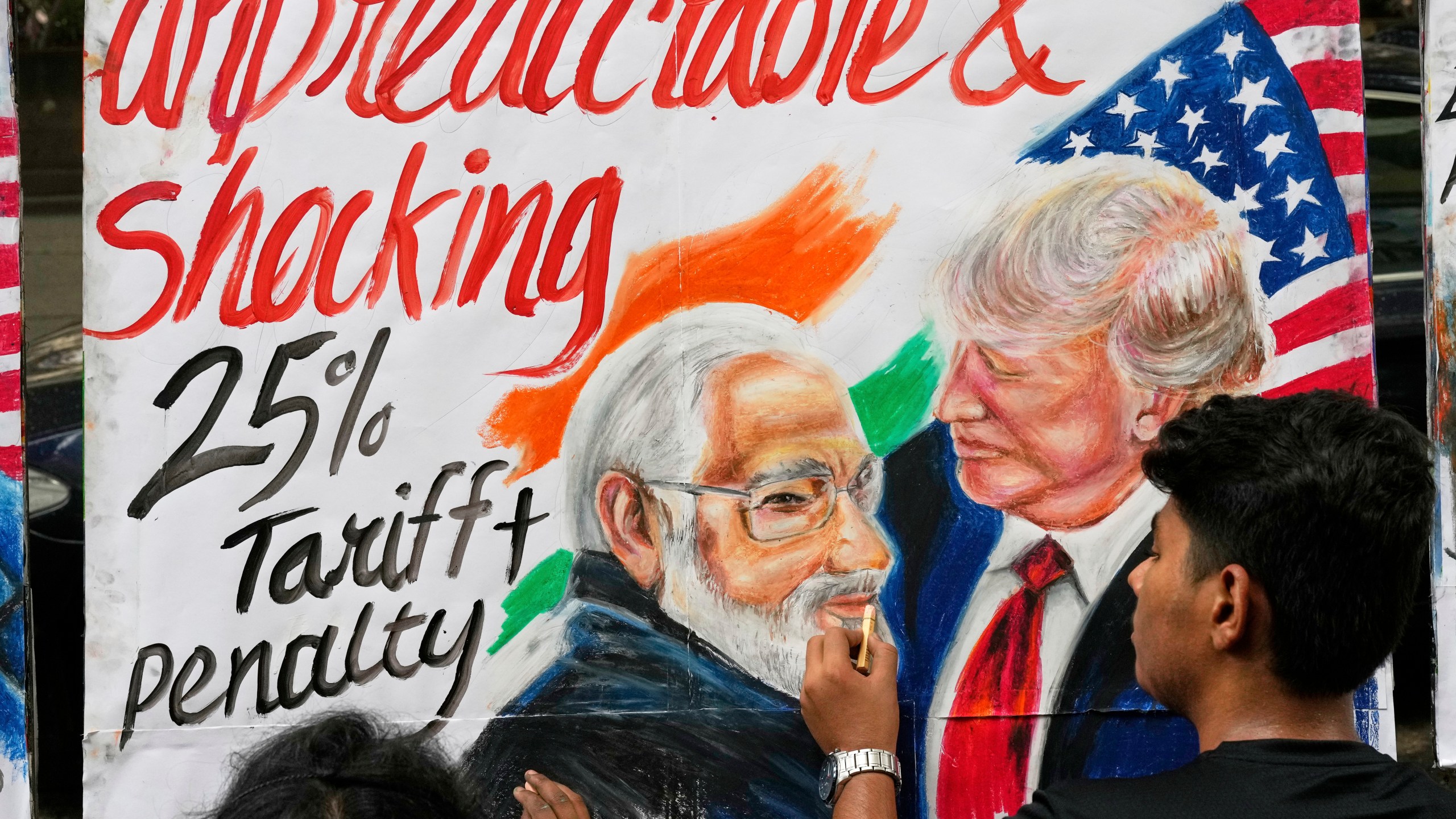 A student of Gurukul school of Art completes artwork of U.S. President Donald Trump and Prime Minister of India Narendra Modi, in Mumbai, India, Friday, Aug. 1, 2025. (AP Photo/Rajanish Kakade)