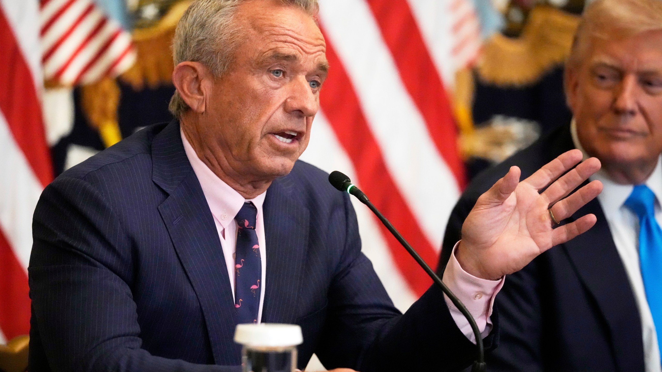 Health and Human Services Secretary Robert F. Kennedy Jr. speaks as President Donald Trump listens at an event to promote his proposal to improve Americans' access to their medical records in the East Room of the White House, Wednesday, July 30, 2025, in Washington. (AP Photo/Mark Schiefelbein)