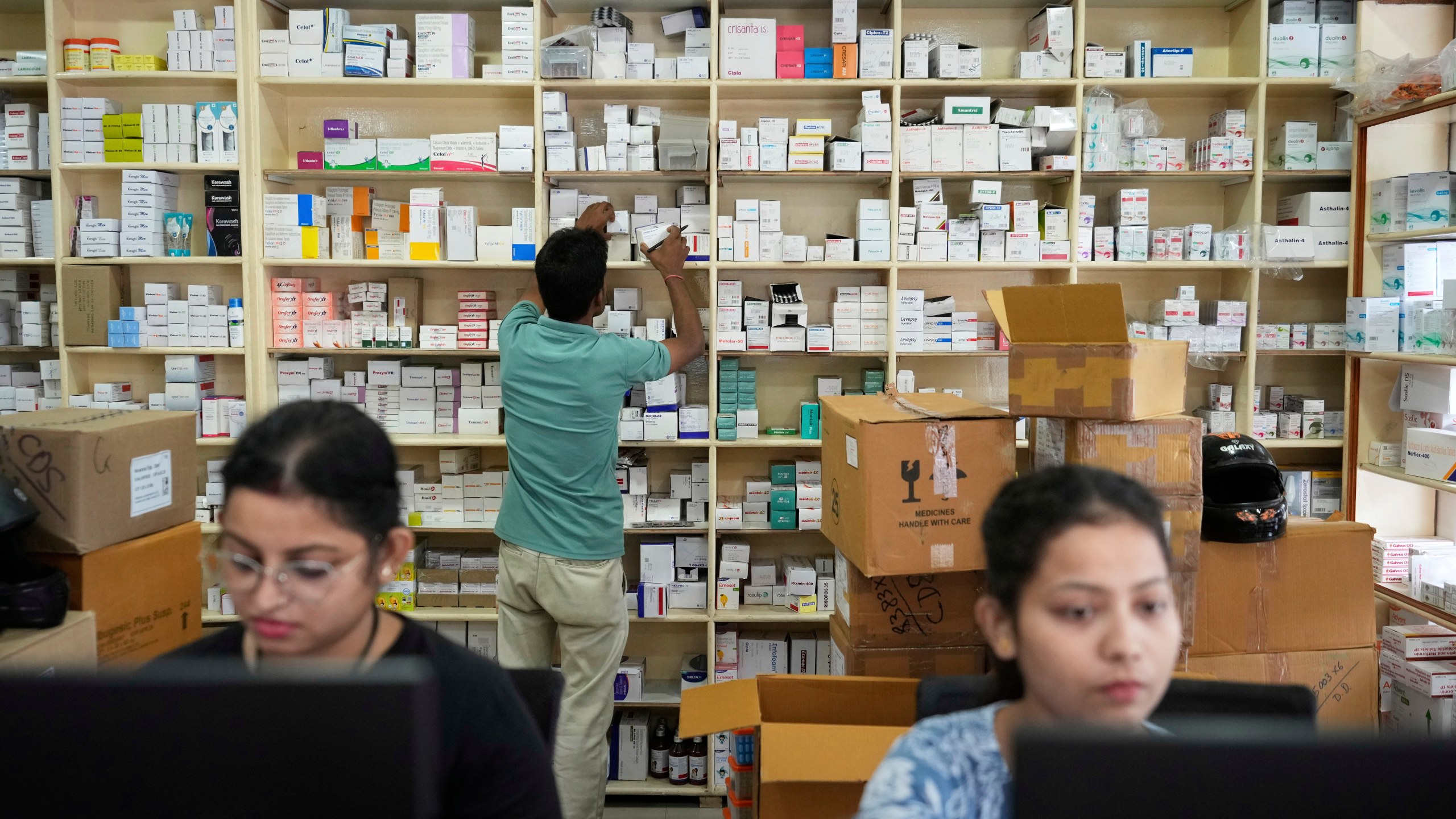 An employee sorts medicines in a medicine wholesale shop in Guwahati, India, Thursday, Aug. 7, 2025. (AP Photo/Anupam Nath)