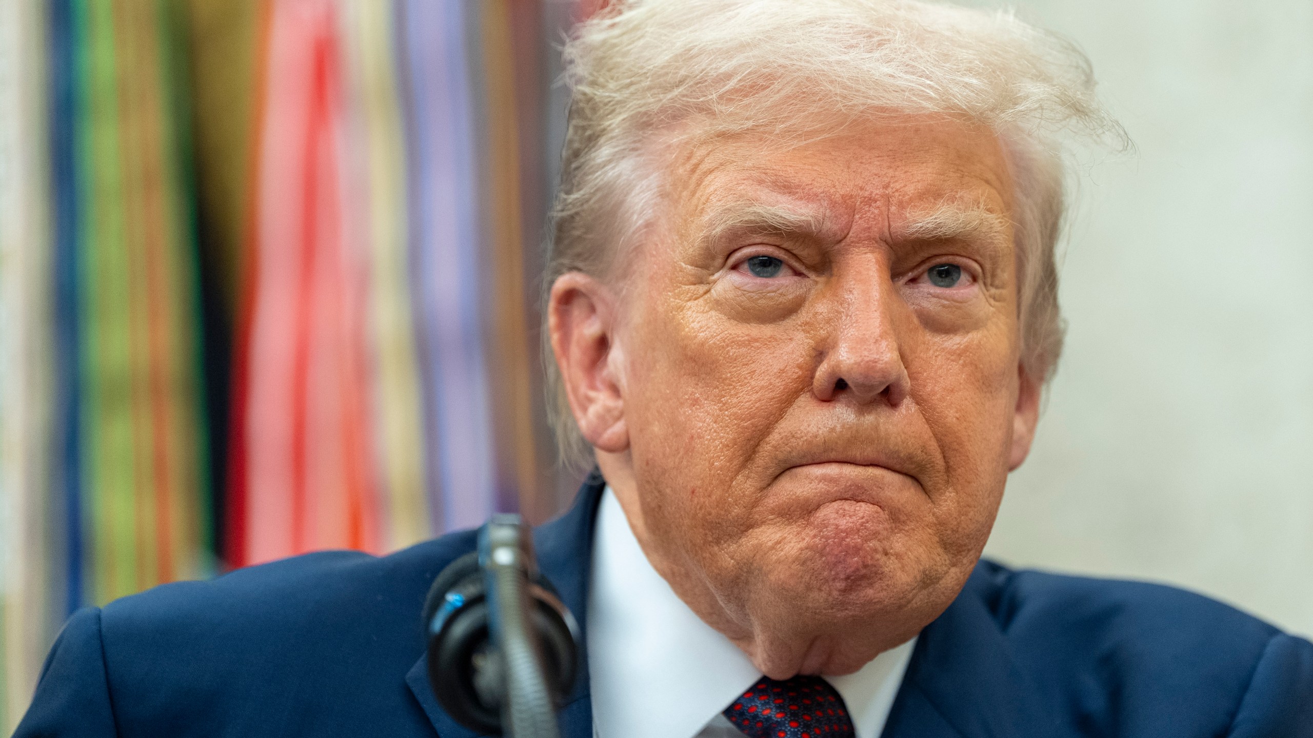 President Donald Trump pauses while speaking during an announcement about Apple with Apple CEO Tim Cook in the Oval Office, Wednesday, Aug. 6, 2025, in Washington. (AP Photo/Alex Brandon)