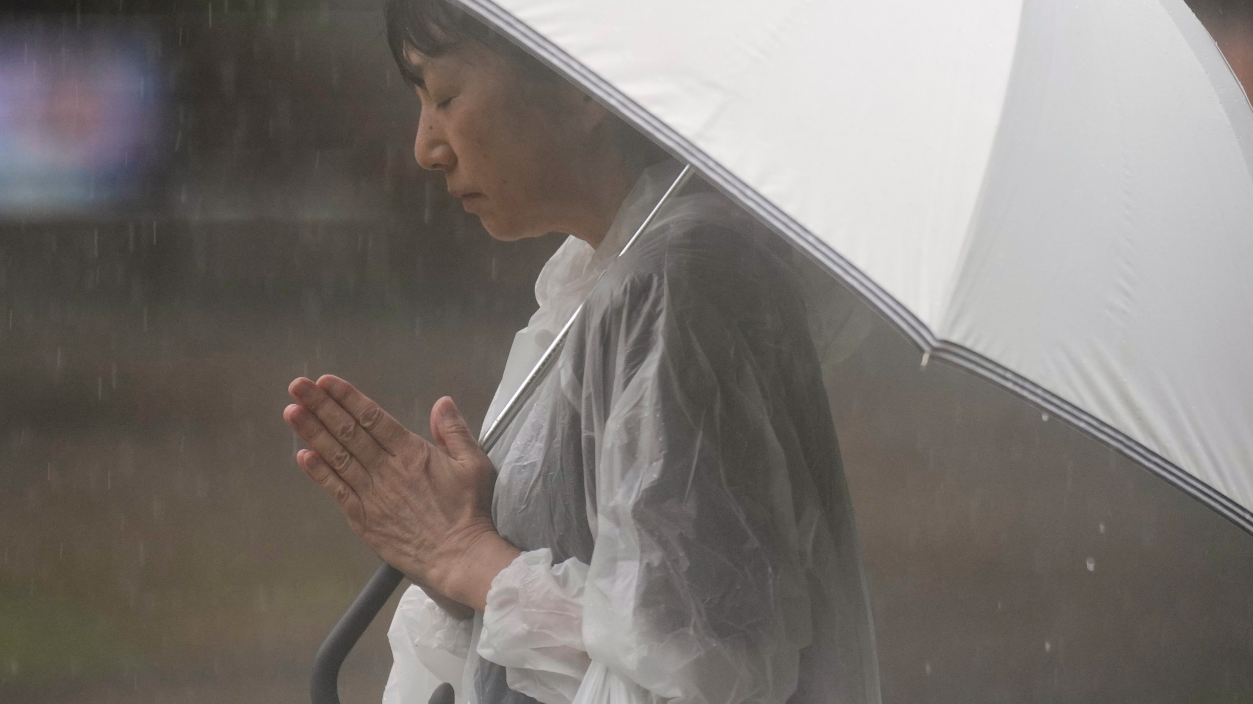 A person prays, ahead of a ceremony to mark the 80th anniversary of the WWII U.S. atomic bombing at Atomic Bomb Hypocenter Park in Nagasaki, western Japan Saturday, Aug. 9, 2025. (AP Photo/Eugene Hoshiko)
