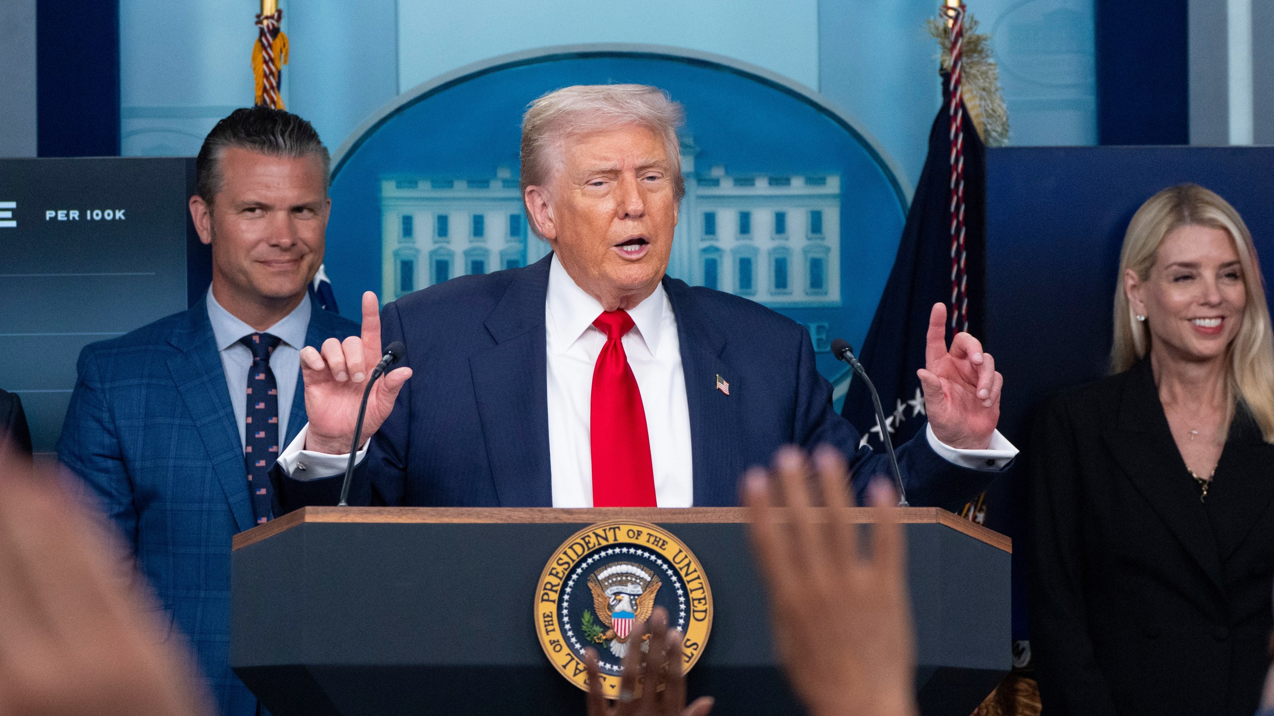 President Donald Trump speaks with reporters in the James Brady Press Briefing Room at the White House, Monday, Aug. 11, 2025, in Washington, as Secretary of Defense Pete Hegseth and Attorney General Pam Bondi look on. (AP Photo/Alex Brandon)