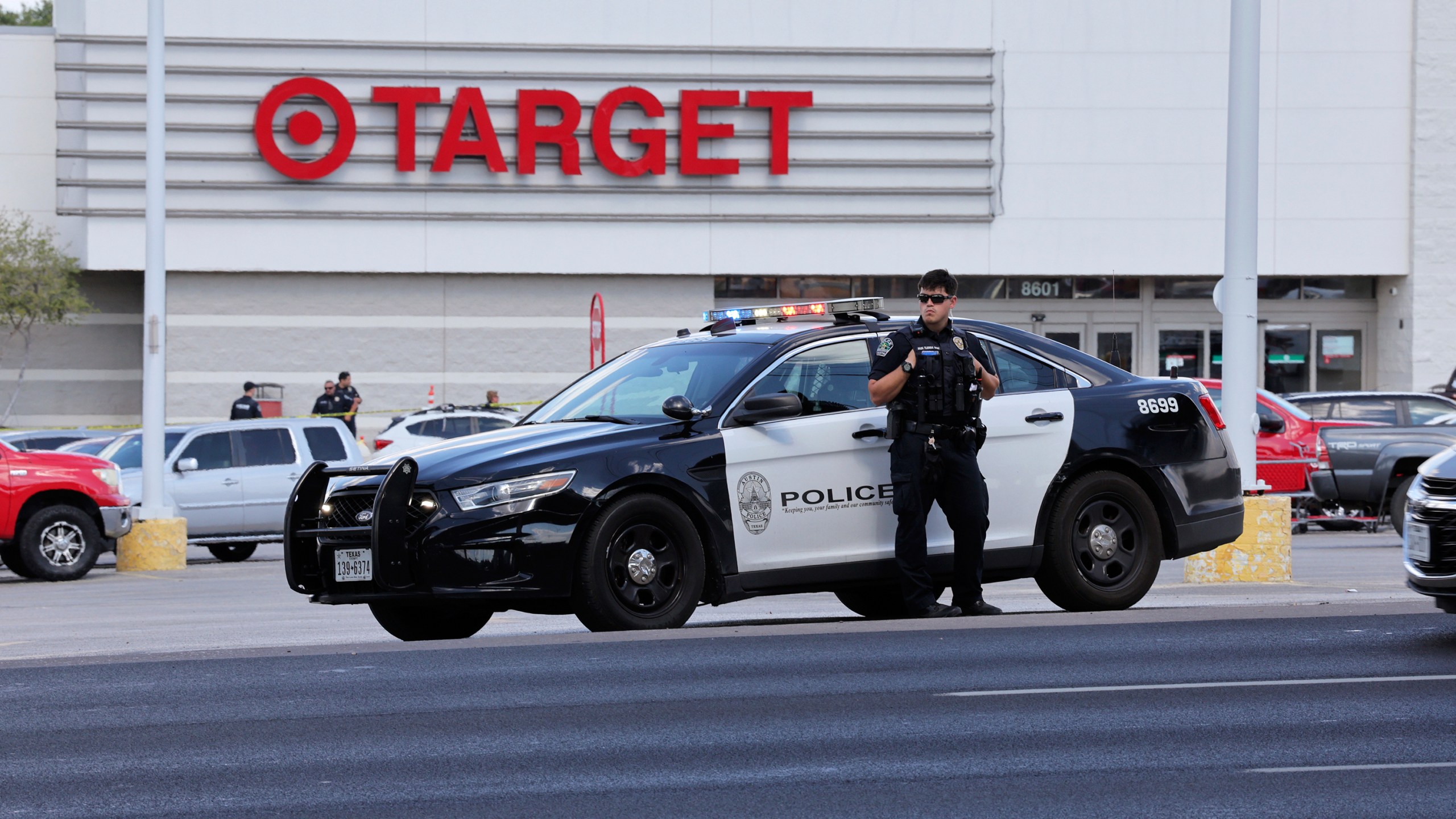 Police block the entrance to a Target after a shooting in Austin, Texas, Monday, Aug. 11, 2025. (AP Photo/Stephen Spillman)