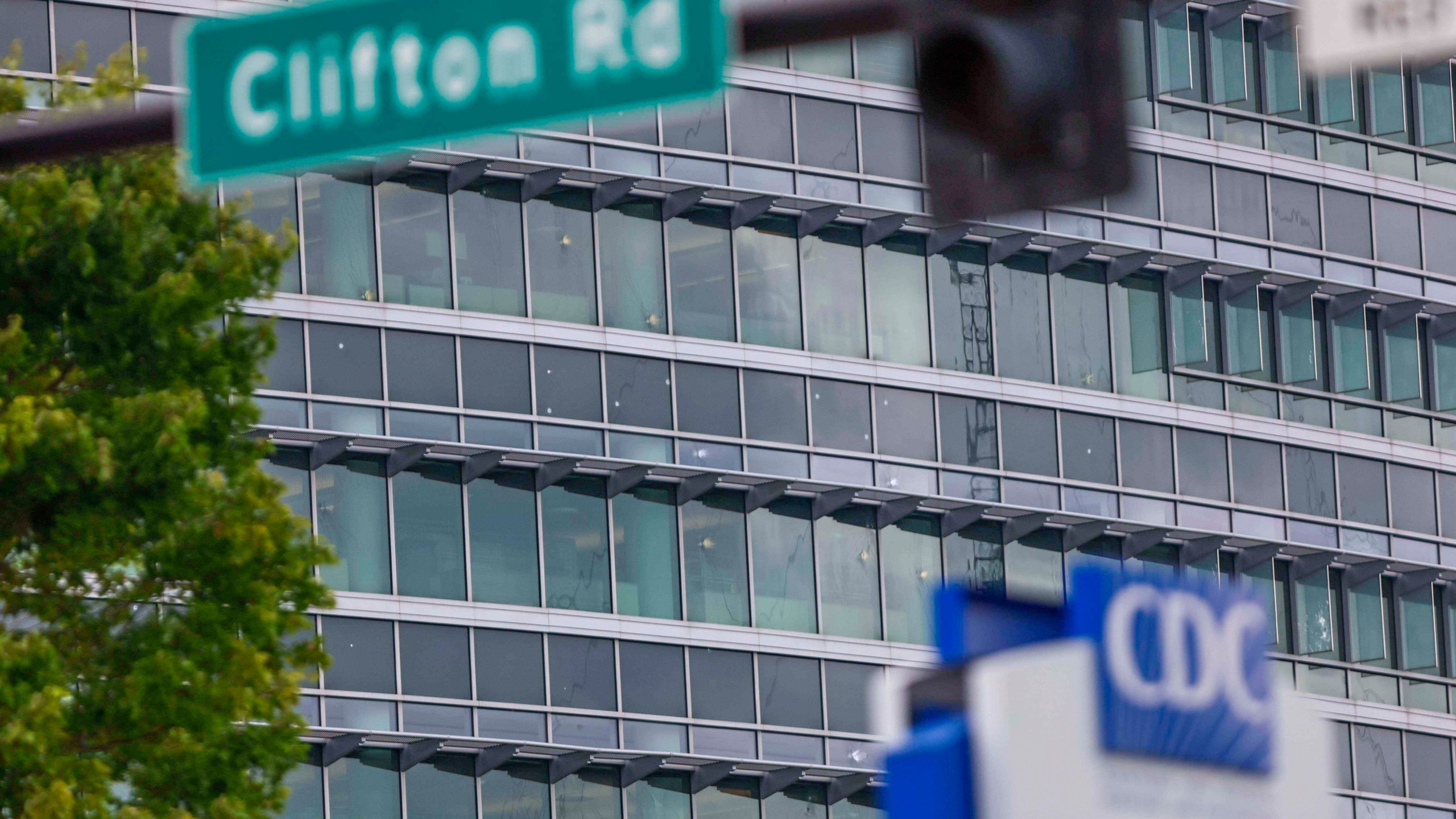 The notable bullet marks on the windows of the Centers for Disease Control and Prevention headquarters are visible on Sunday Aug. 10, 2025. (Miguel Martinez/Atlanta Journal-Constitution via AP)