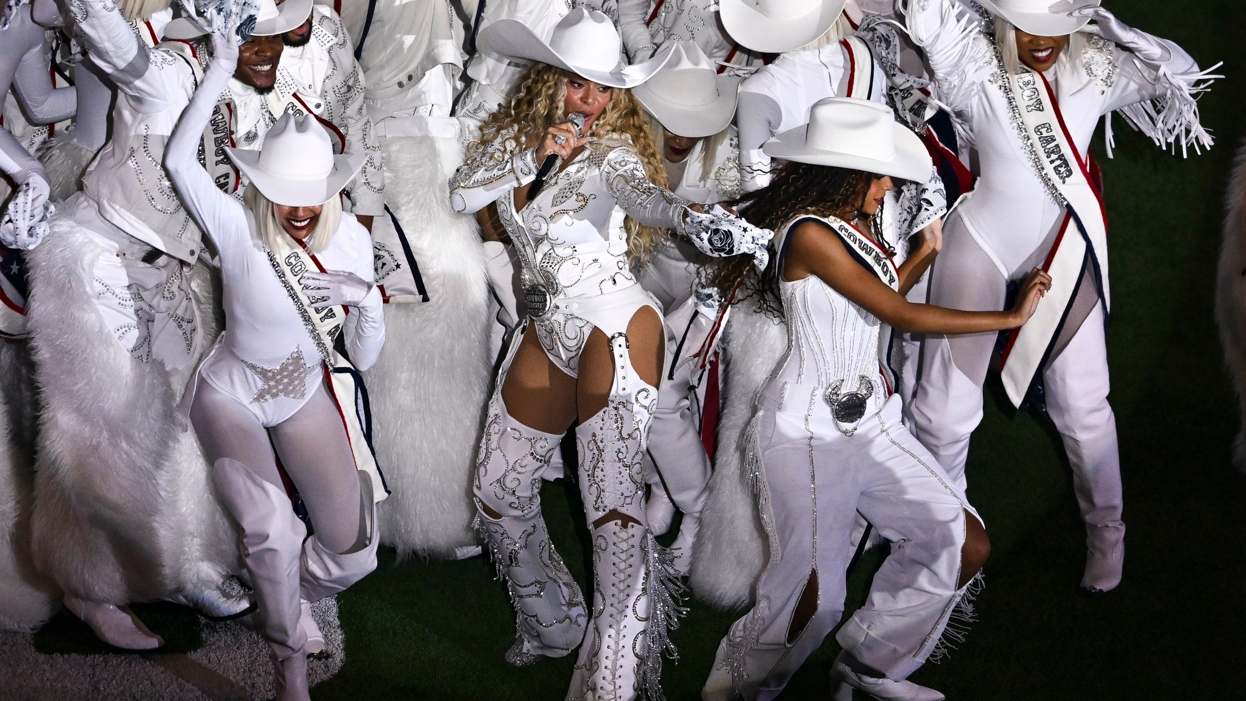 Beyoncé is surrounded by dancers during a halftime performance