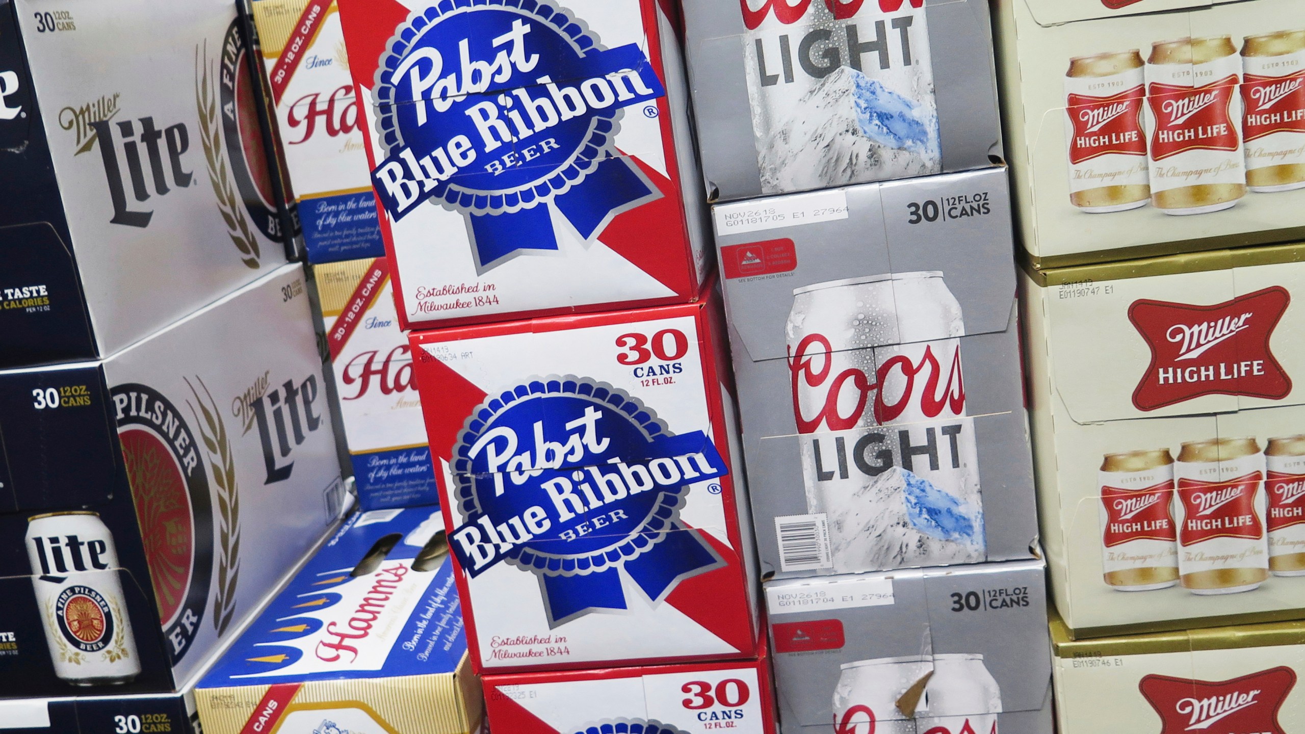 FILE - Cases of beer are stacked in a Milwaukee liquor store on Nov. 8, 2018. (AP Photo/Ivan Moreno, File)