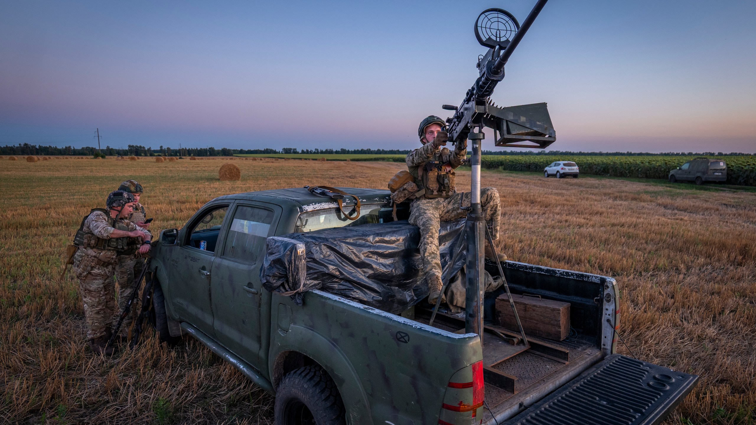 Ukrainian servicemen of the 15th Army Corps stand by an armed pickup truck during night duty in the Chernihiv region, Ukraine, late Tuesday, Aug. 12, 2025. (AP Photo/Dan Bashakov)