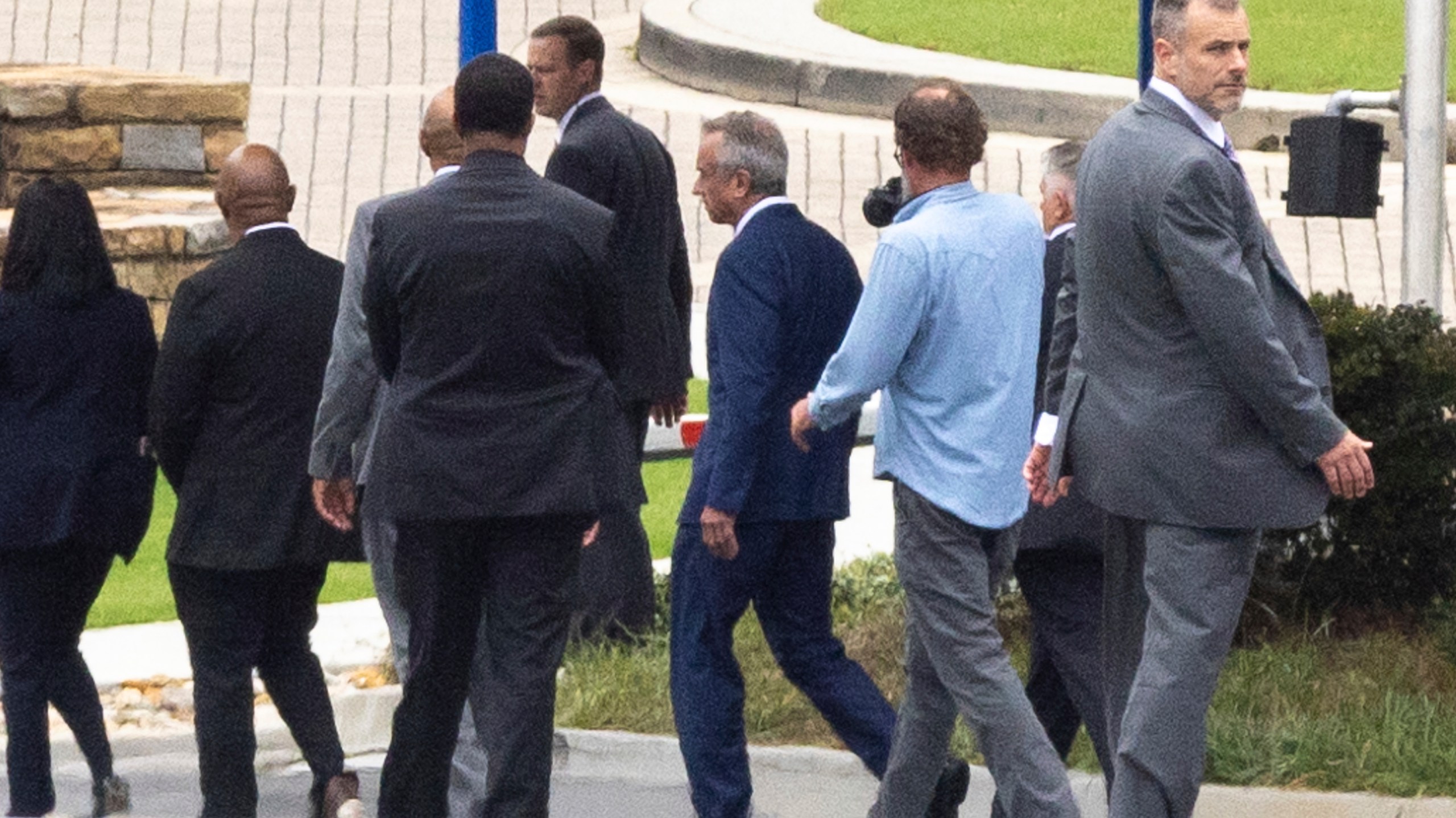 Secretary of Health and Human Services Robert F. Kennedy Jr., center, visits the Centers for Disease Control and Prevention headquarters in Atlanta, Monday, Aug. 11, 2025. (Arvin Temkar/Atlanta Journal-Constitution via AP)