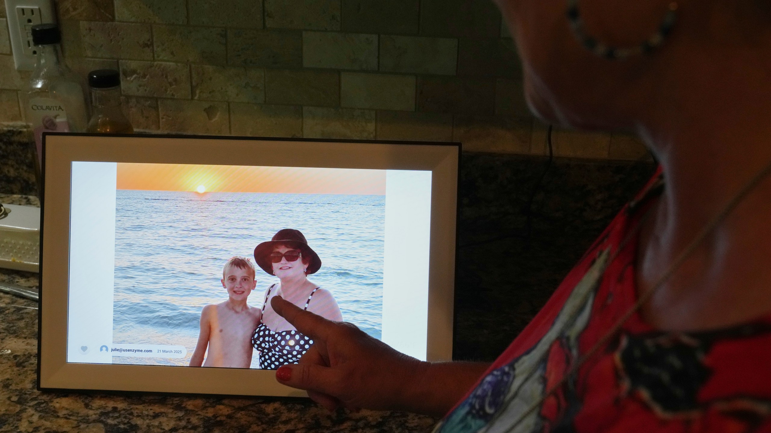 Julie Nicoll shows shows an undated photo with her grandson Xavier Thursday, April 24, 2025, in Naples, Fla. Julie and her husband have spent more than $20,000 in legal fees trying to get him released from a youth detention center. (AP Photo/Marta Lavandier)