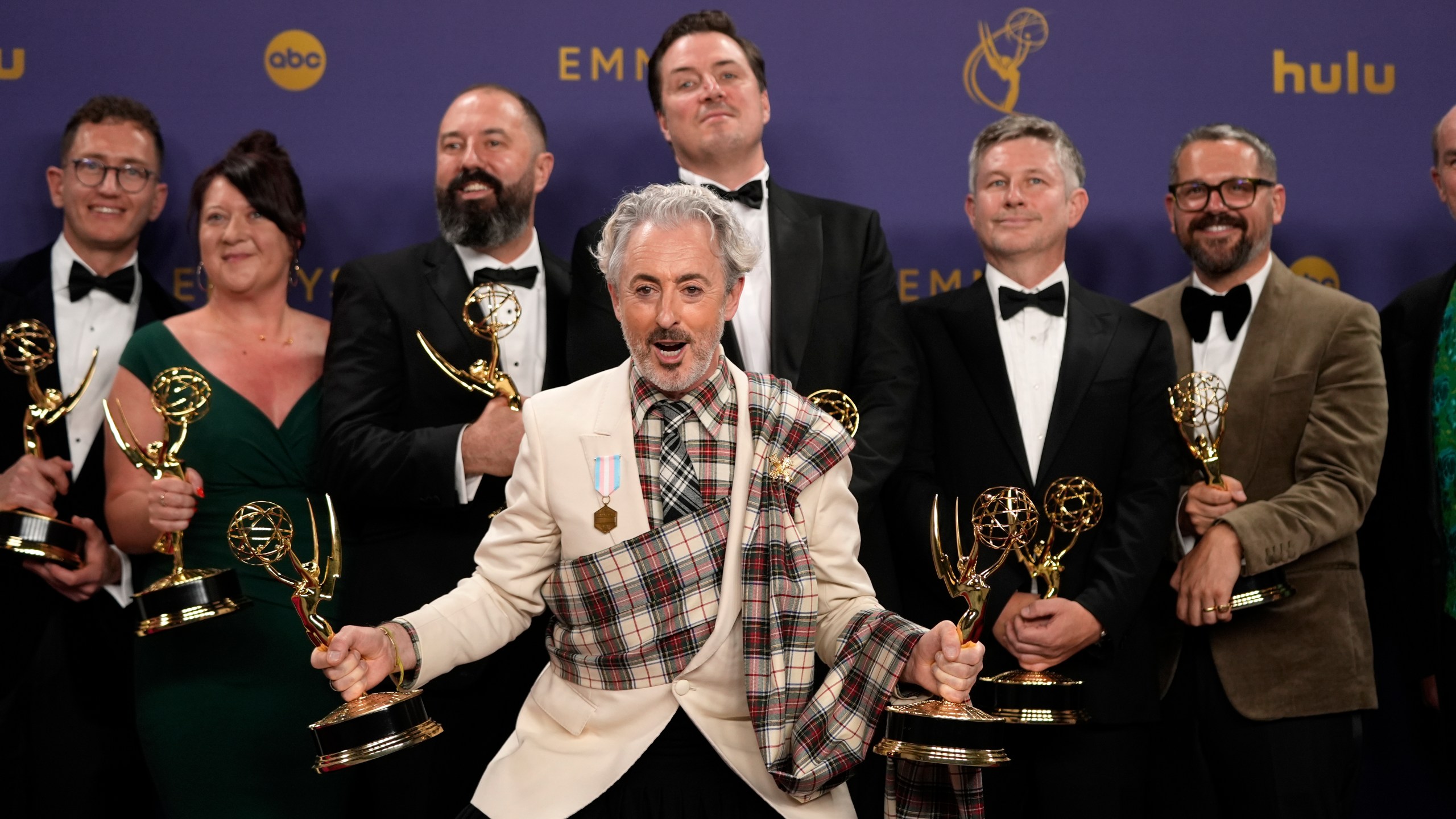 FILE - Alan Cumming, center, and the team from "The Traitors" pose in the press room with the award for outstanding reality competition program during the 76th Primetime Emmy Awards, Sept. 15, 2024, at the Peacock Theater in Los Angeles. (AP Photo/Jae C. Hong, File)