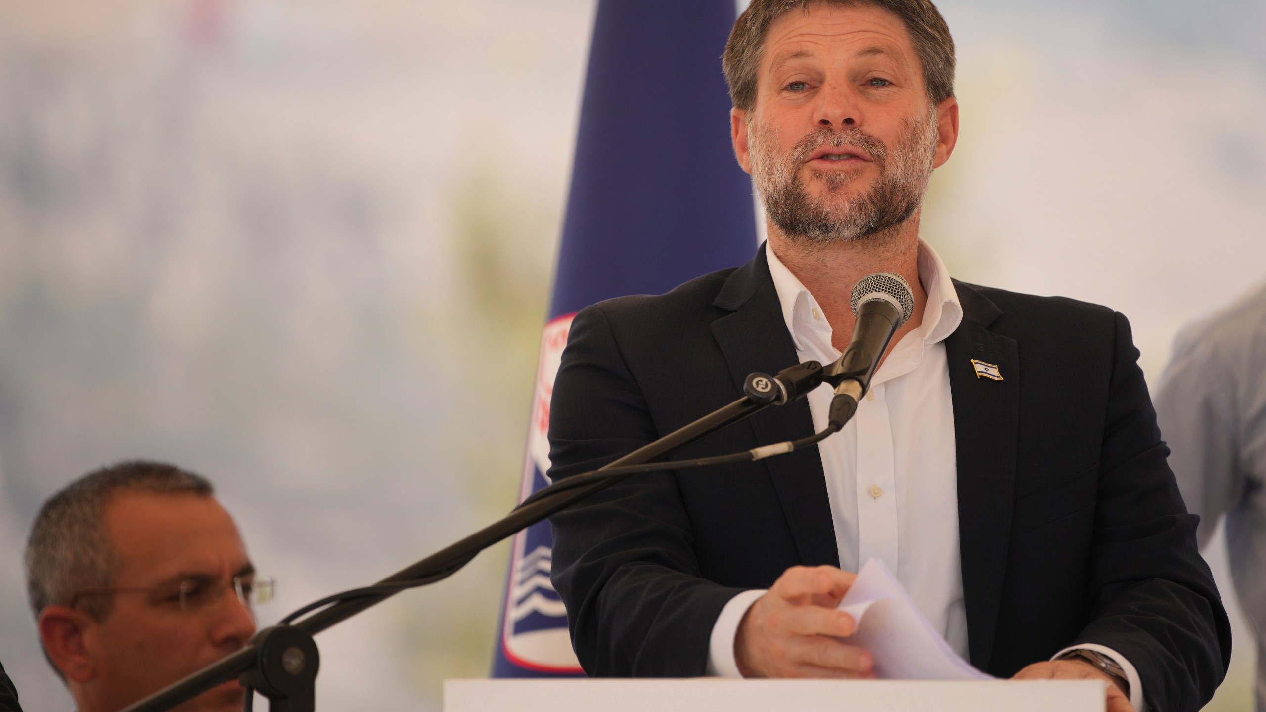 CORRECTS DAY Israeli Finance Minister Bezalel Smotrich speaks to journalists during a press conference about new settlement construction in the Israel-occupied West Bank near Maale Adumim, Thursday, Aug. 14, 2025. (AP Photo/Ohad Zwigenberg)