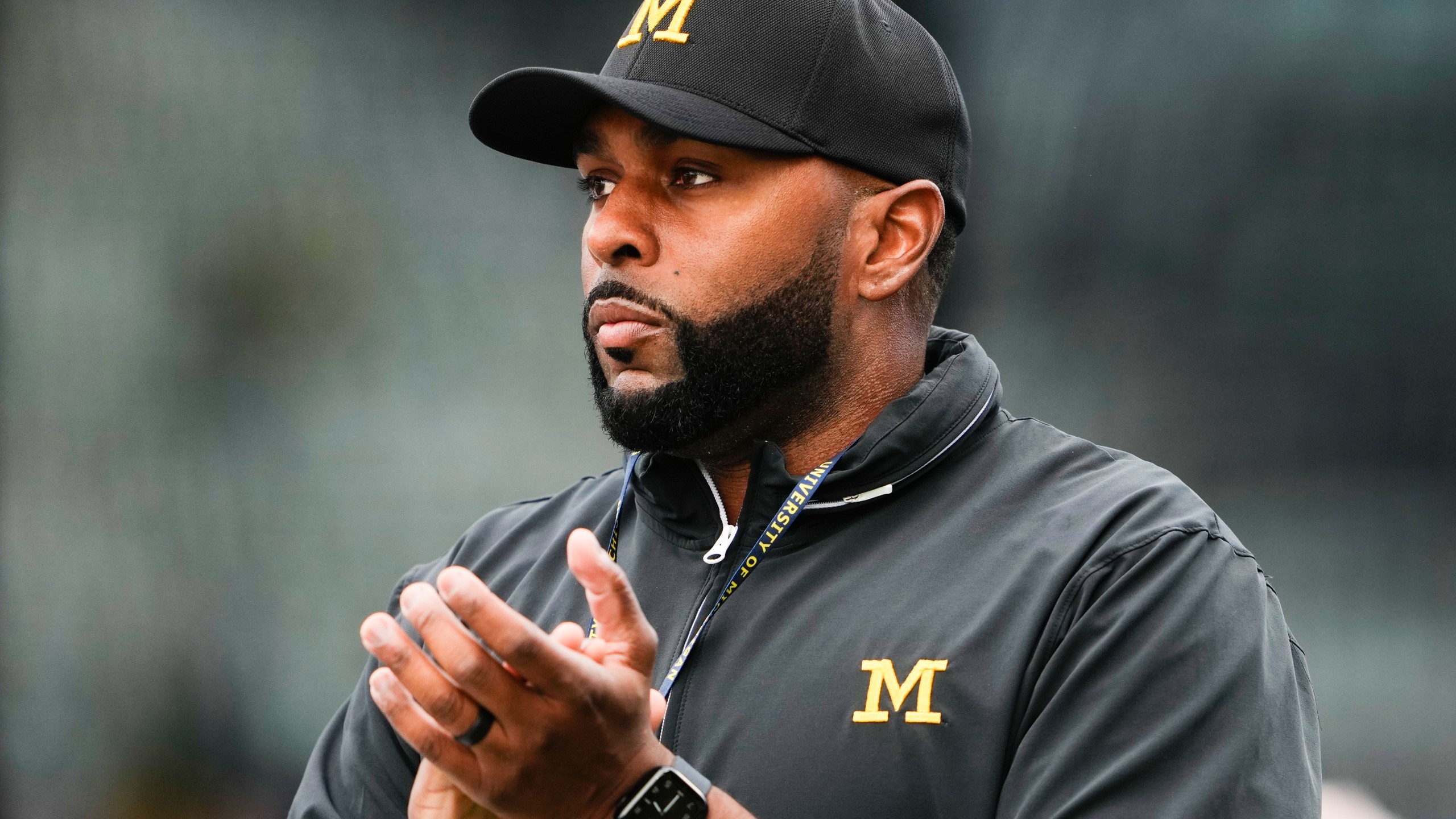 FILE - Michigan head coach Sherrone Moore walks on the field before an NCAA college football game against Washington, Saturday, Oct. 5, 2024, in Seattle. (AP Photo/Lindsey Wasson)