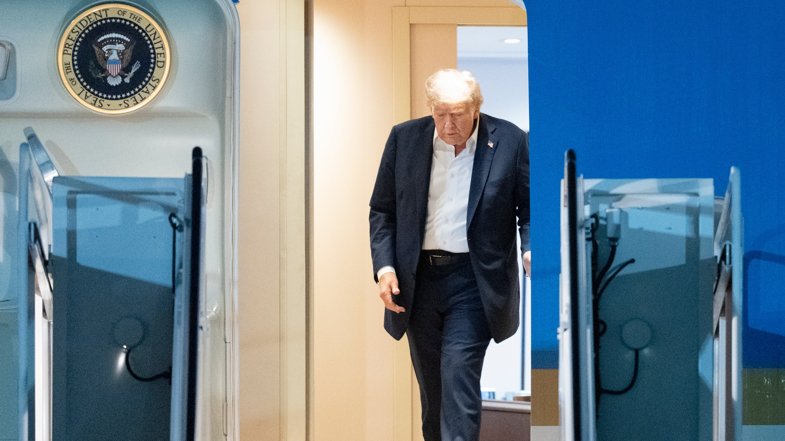 President Donald Trump walks to disembark Air Force One as he arrives at Joint Base Andrews, Md., early Saturday, Aug. 16, 2025, from a summit with Russian President Vladimir Putin in Anchorage, Alaska. (AP Photo/Manuel Balce Ceneta)