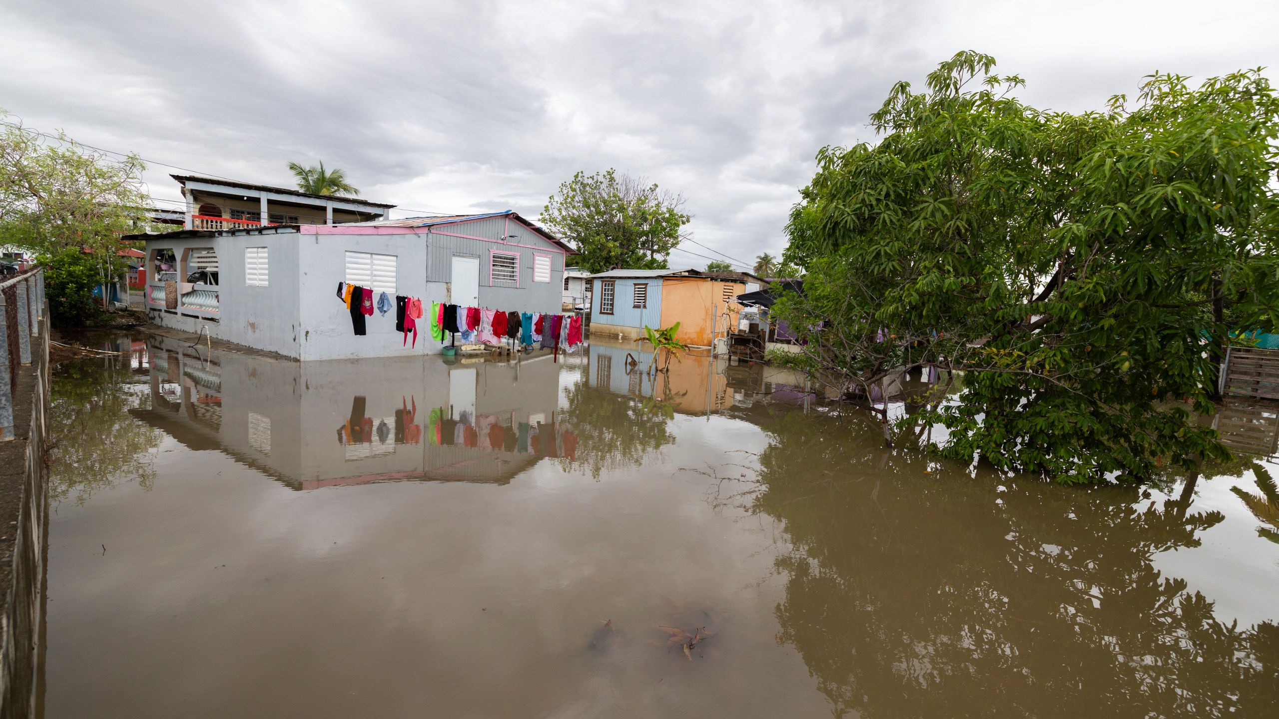 Water surrounds a house in Guayama, Puerto Rico, as Hurricane Erin brings rains to the island, Sunday, Aug. 17, 2025. (AP Photo/Alejandro Granadillo)
