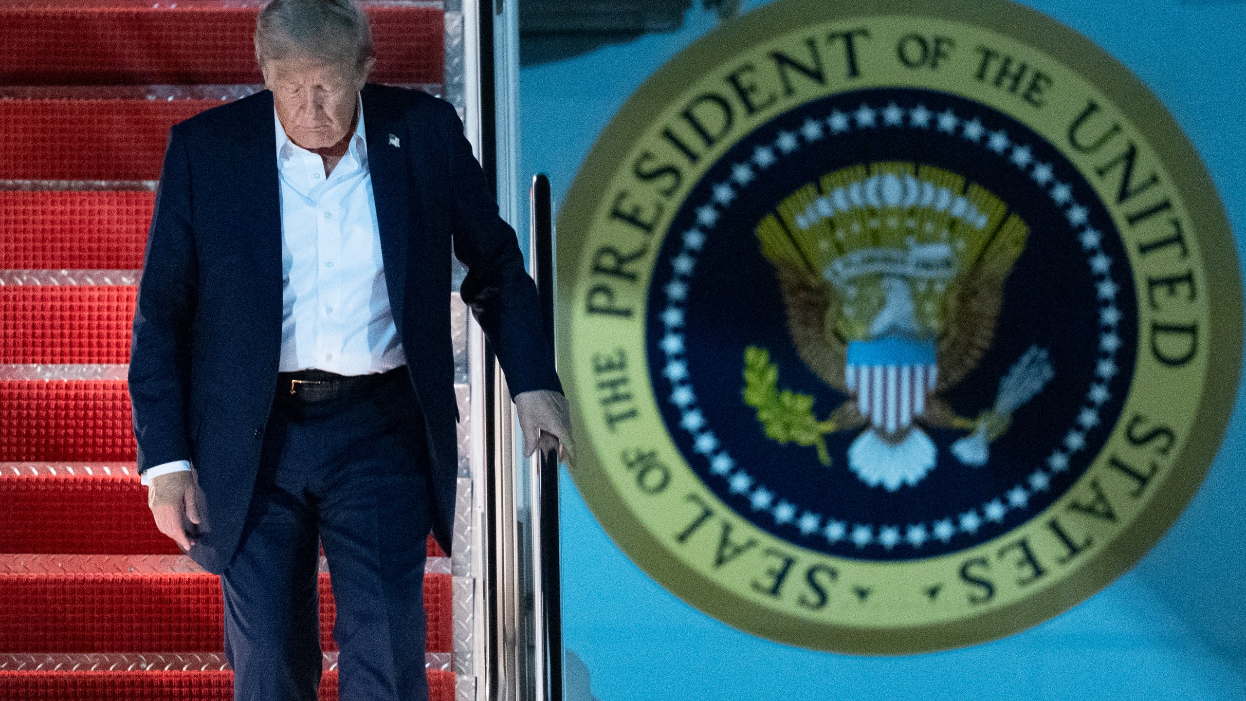 President Donald Trump disembarks Air Force One as he arrives at Joint Base Andrews, Md., early Saturday, Aug. 16, 2025, from a summit with Russian President Vladimir Putin in Anchorage, Alaska. (AP Photo/Manuel Balce Ceneta)