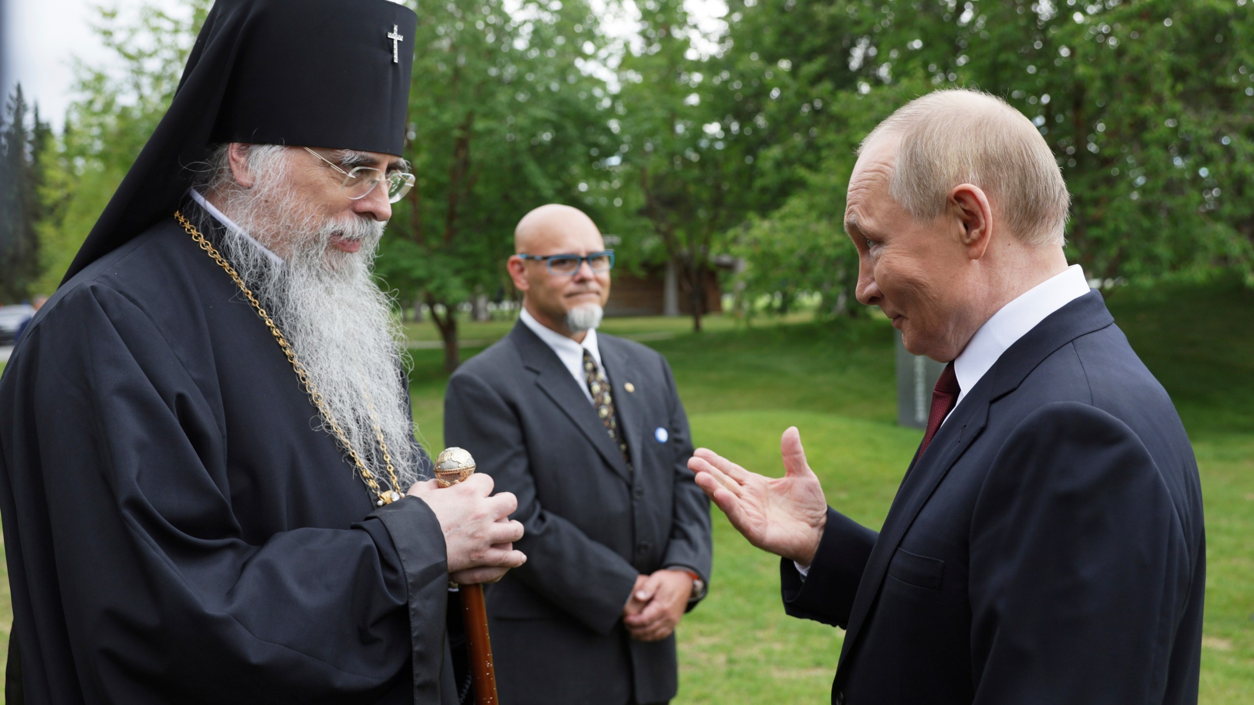 Russia's President Vladimir Putin, right, and Alexei (John Trader), Archbishop of the Orthodox Church in America Diocese of Alaska talk after laying flowers to the graves of Soviet soldiers who died during World War II at Fort Richardson National Cemetery, Alaska, Friday, Aug. 15, 2025, after meeting with U.S. President Donald Trump. (Gavriil Grigorov, Sputnik, Kremlin Pool Photo via AP)