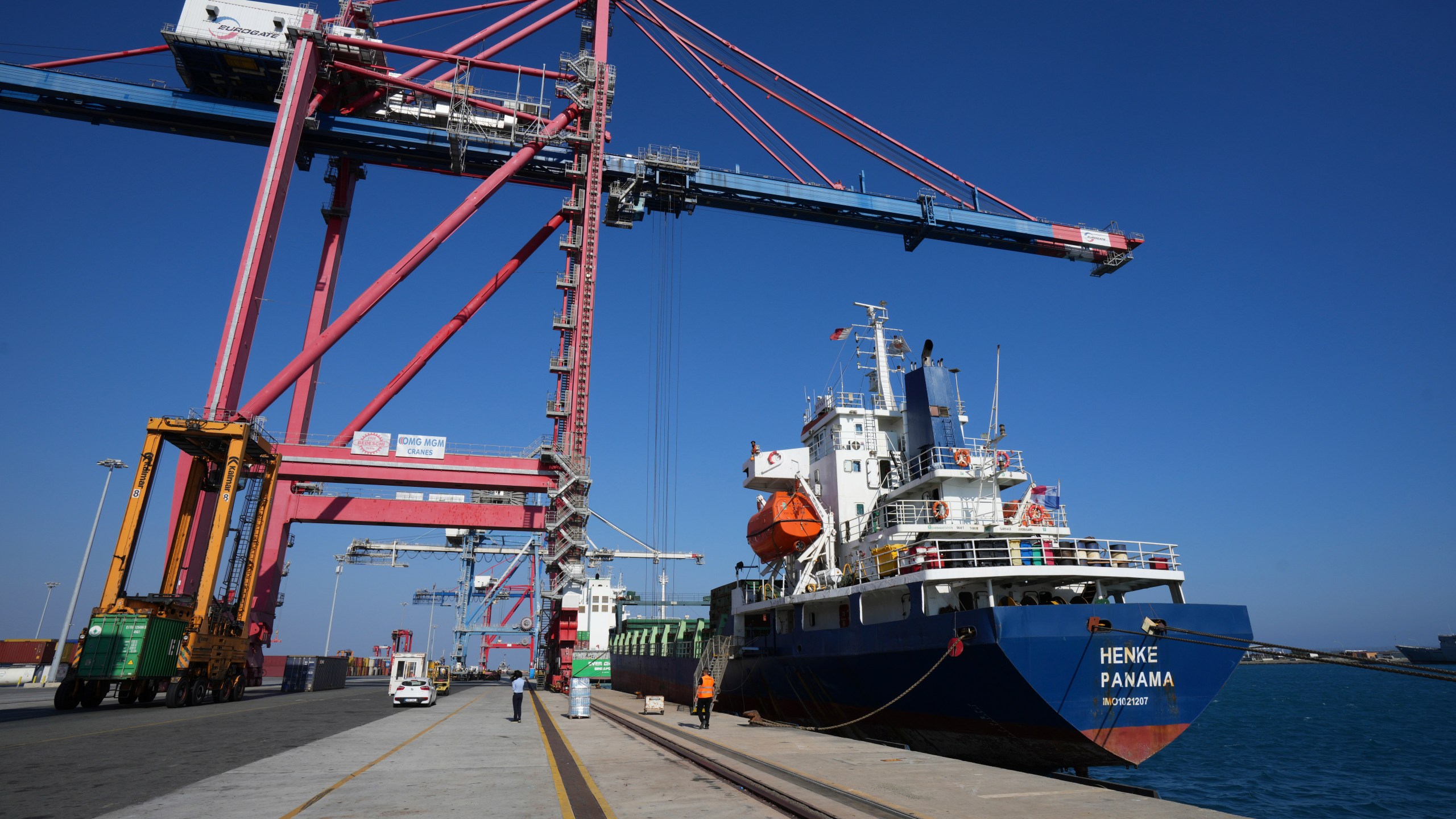 Containers loaded with humanitarian aid for the people of Gaza, including flour, pasta, baby food and canned goods, is being loaded aboard a Panamanian-flagged ship at Cyprus' main port in Limassol, on Monday, Aug. 18, 2025. (AP Photo/Petros Karadjias)