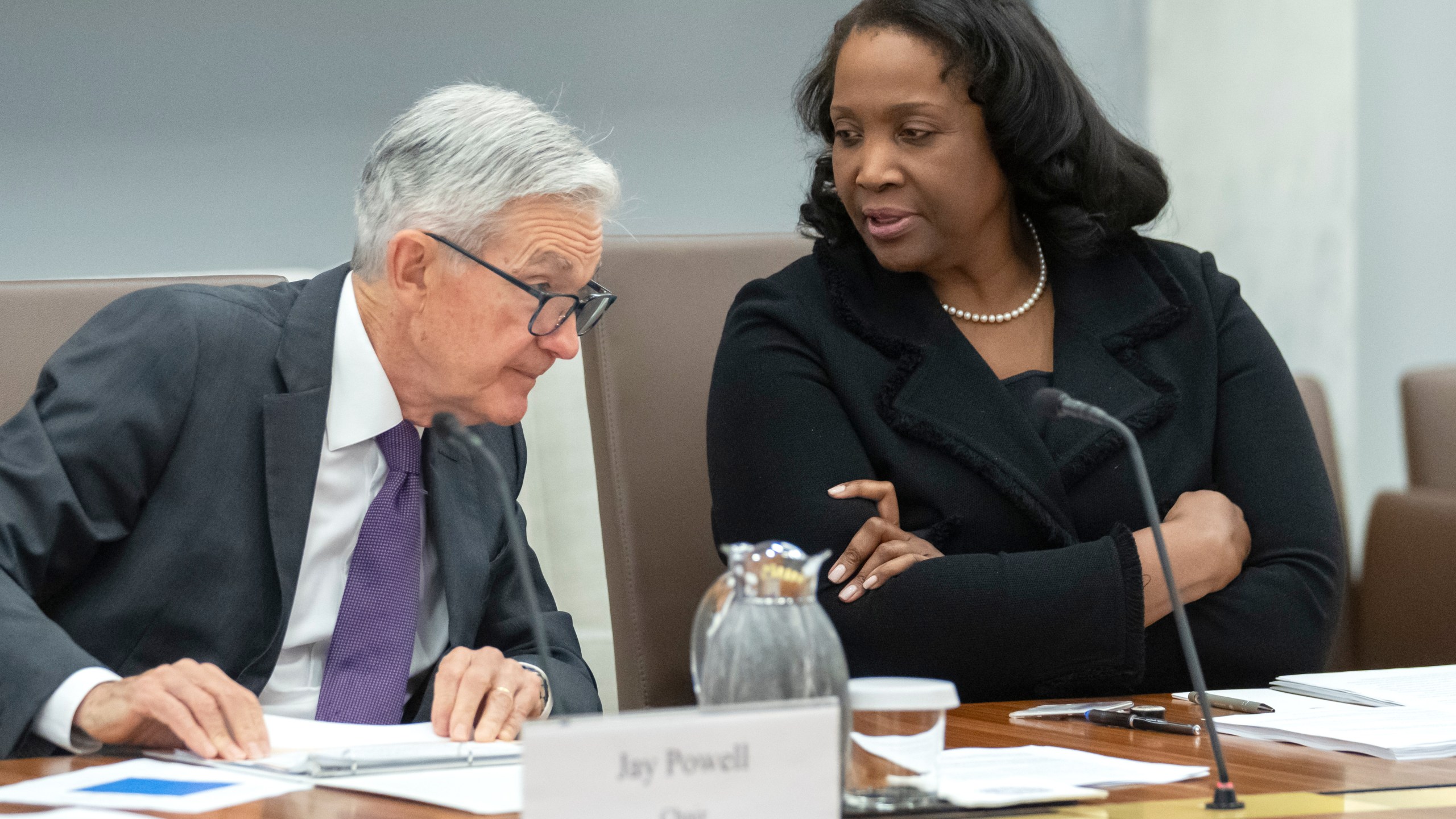 FILE - Federal Reserve Board of Governors member Lisa Cook, right, talks with Federal Reserve Chairman Jerome Powell before an open meeting of the Board of Governors at the Federal Reserve, June 25, 2025, in Washington. (AP Photo/Mark Schiefelbein, File)
