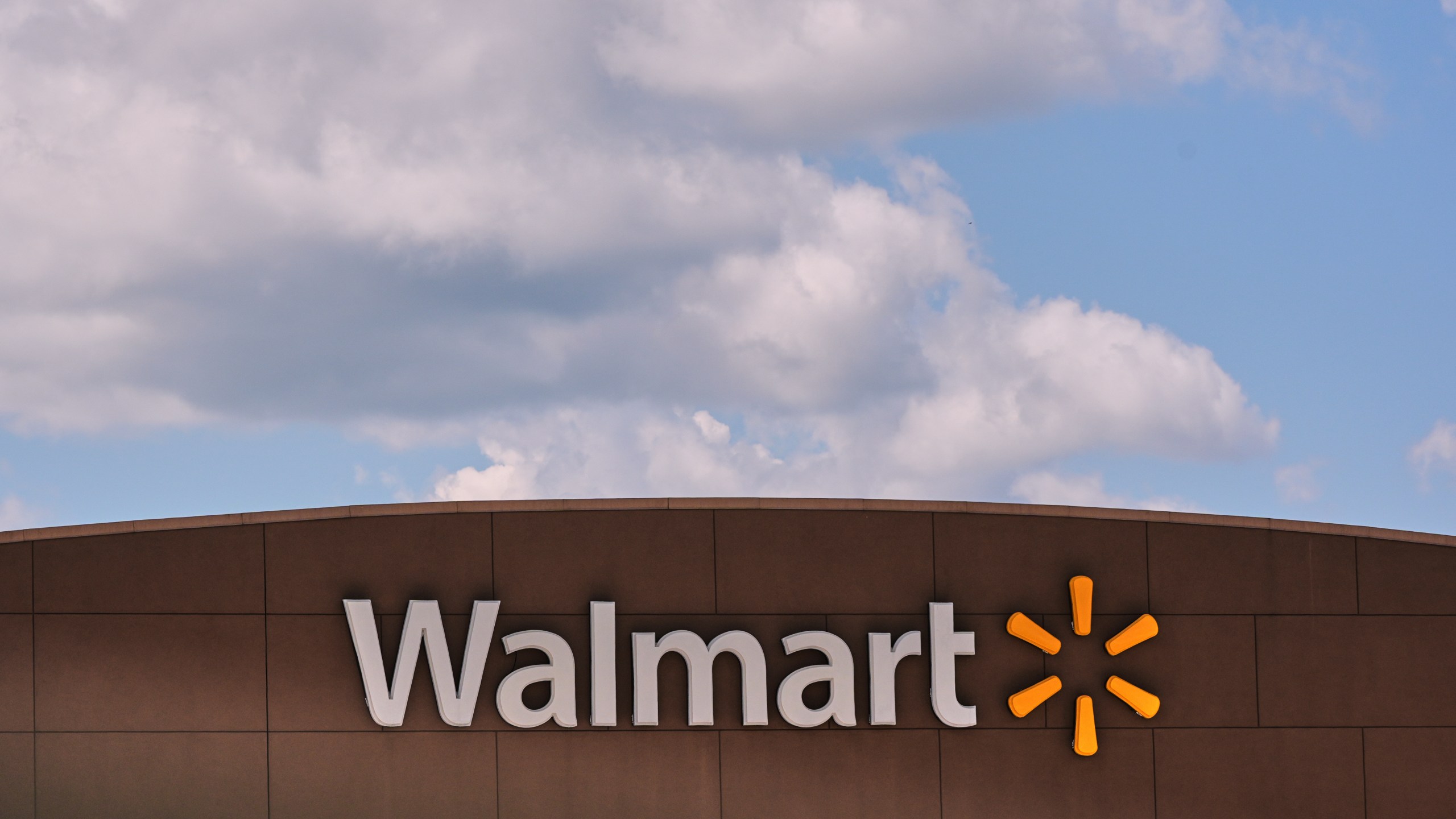 Clouds pass over the Walmart store, Thursday, Aug. 14, 2025, in Manchester, N.H. (AP Photo/Charles Krupa)