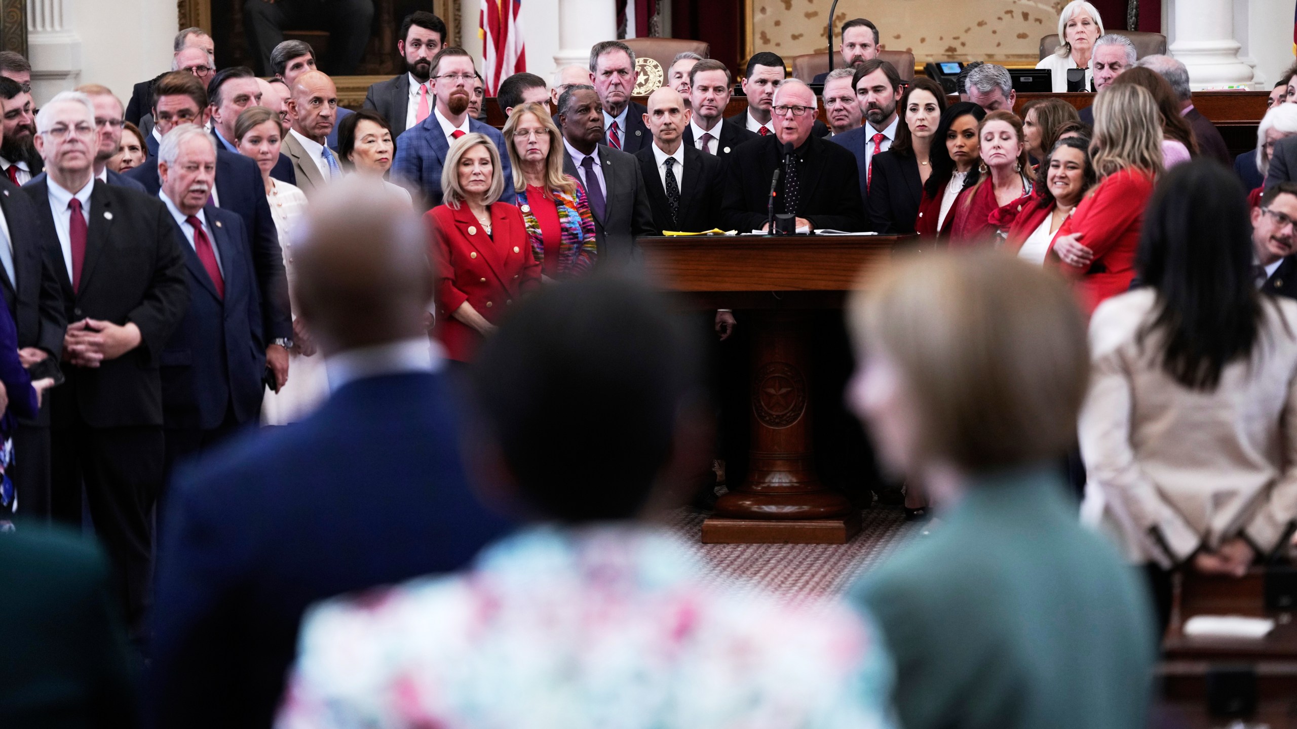 Texas Rep. Todd Hunter, R-Corpus Christi, is surrounded by fellow Republicans as he faces off with Democrats during debate over a redrawn U.S. congressional map in Texas during a special session, Wednesday, Aug. 20, 2025, in Austin, Texas. (AP Photo/Eric Gay)