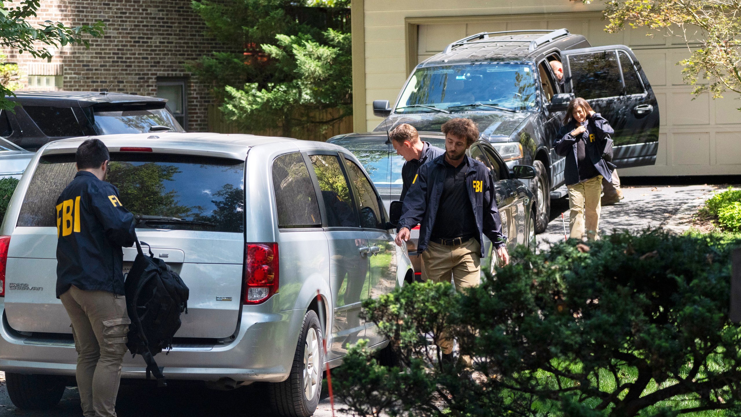 A group of FBI agents leave former national security adviser John Bolton's house where FBI searched the home, Friday, Aug. 22, 2025, in Bethesda, Md. (AP Photo/Manuel Balce Ceneta)