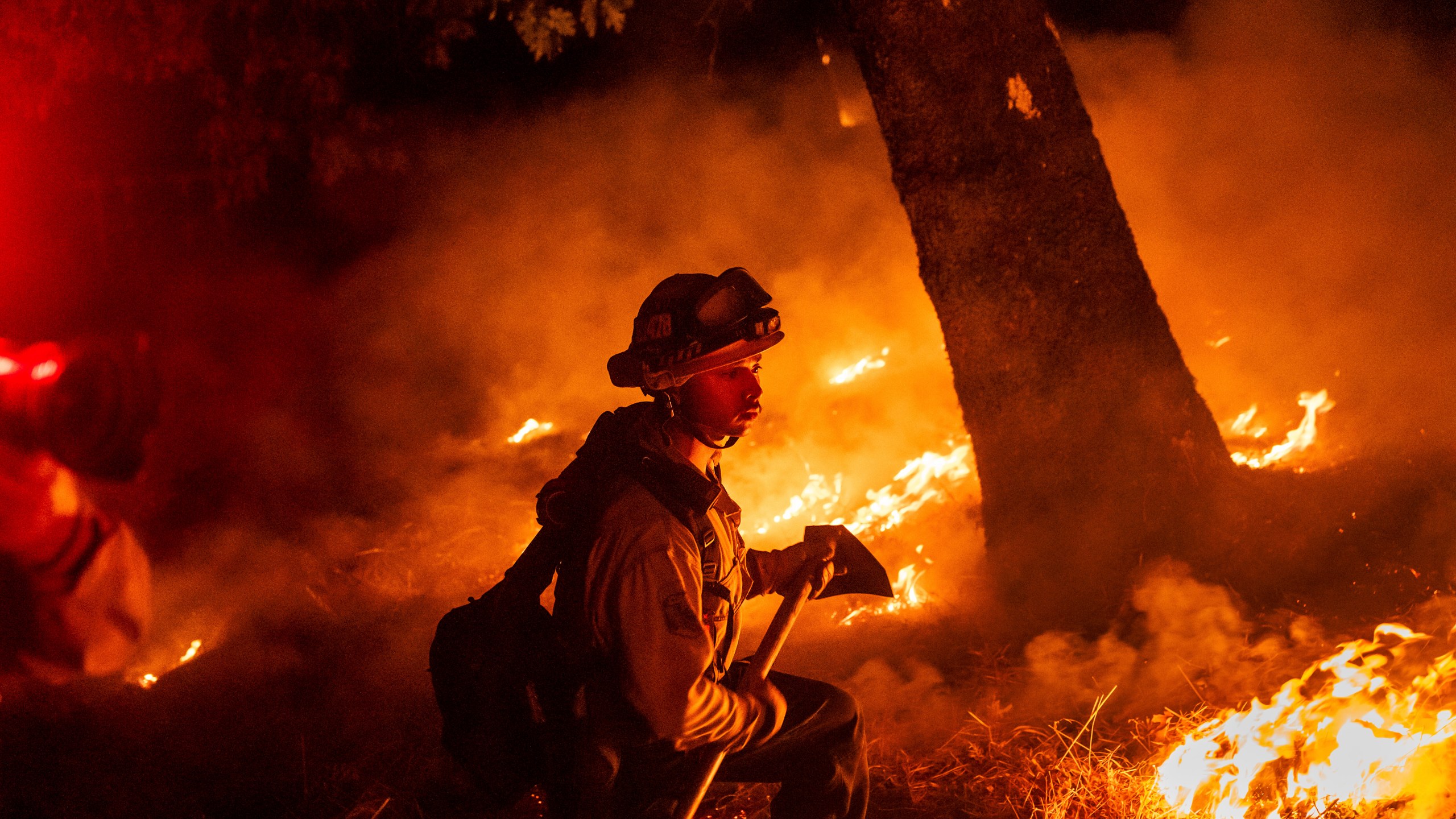 A firefighter is surrounded by flames in Aetna Springs area of Napa County, Calif.
