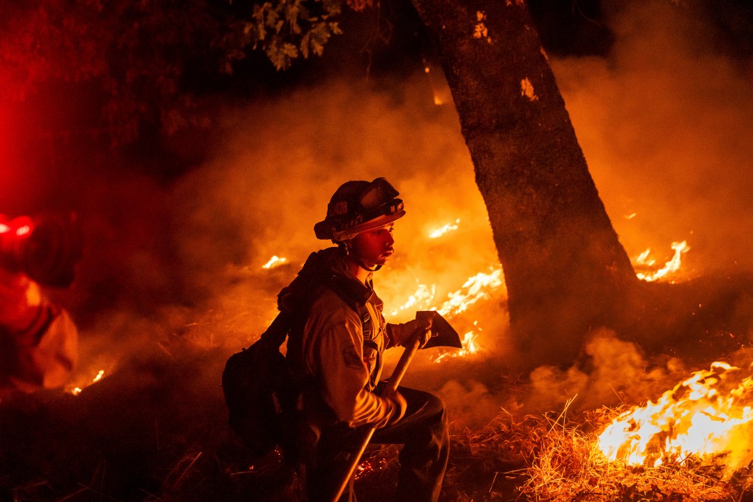 A firefighter is surrounded by flames in Aetna Springs area of Napa County, Calif.