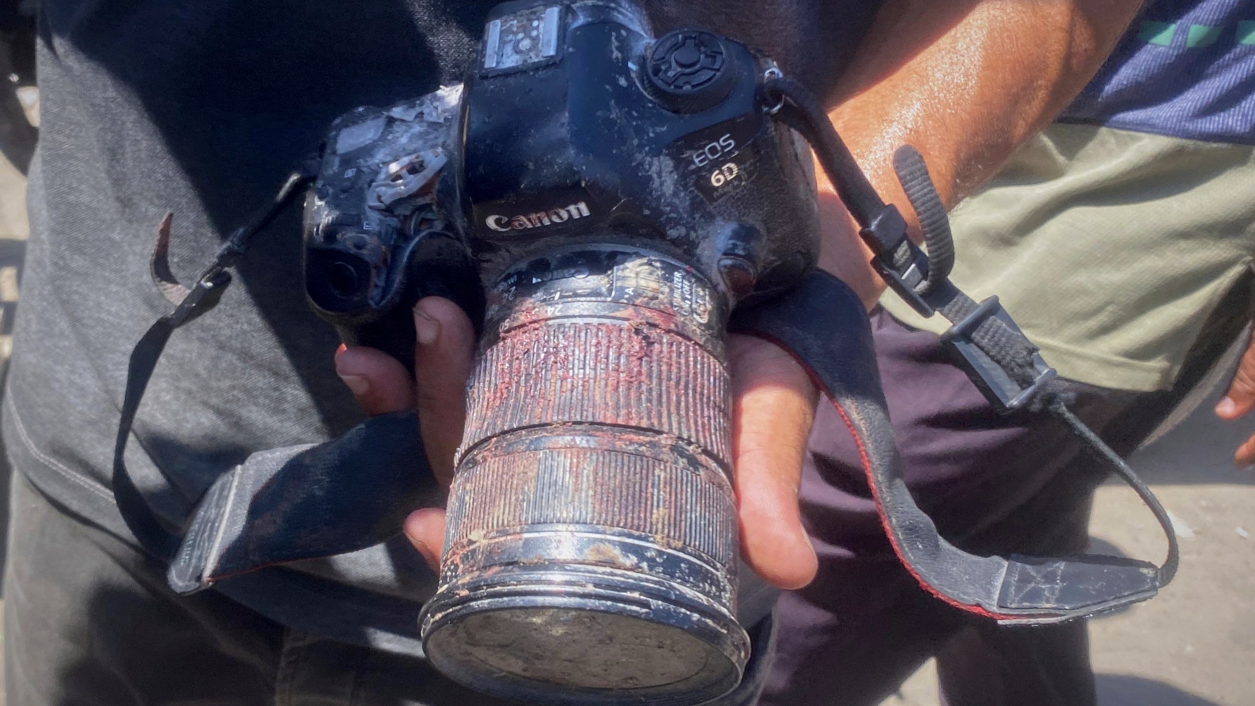 In this family handout photo, a person shows the blood-stained camera that freelance journalist Mariam Dagga, 33, was carrying when she was killed in a double Israeli strike on Nasser Hospital in Khan Younis, southern Gaza Strip, Monday, Aug. 25, 2025. (Family Handout via AP)