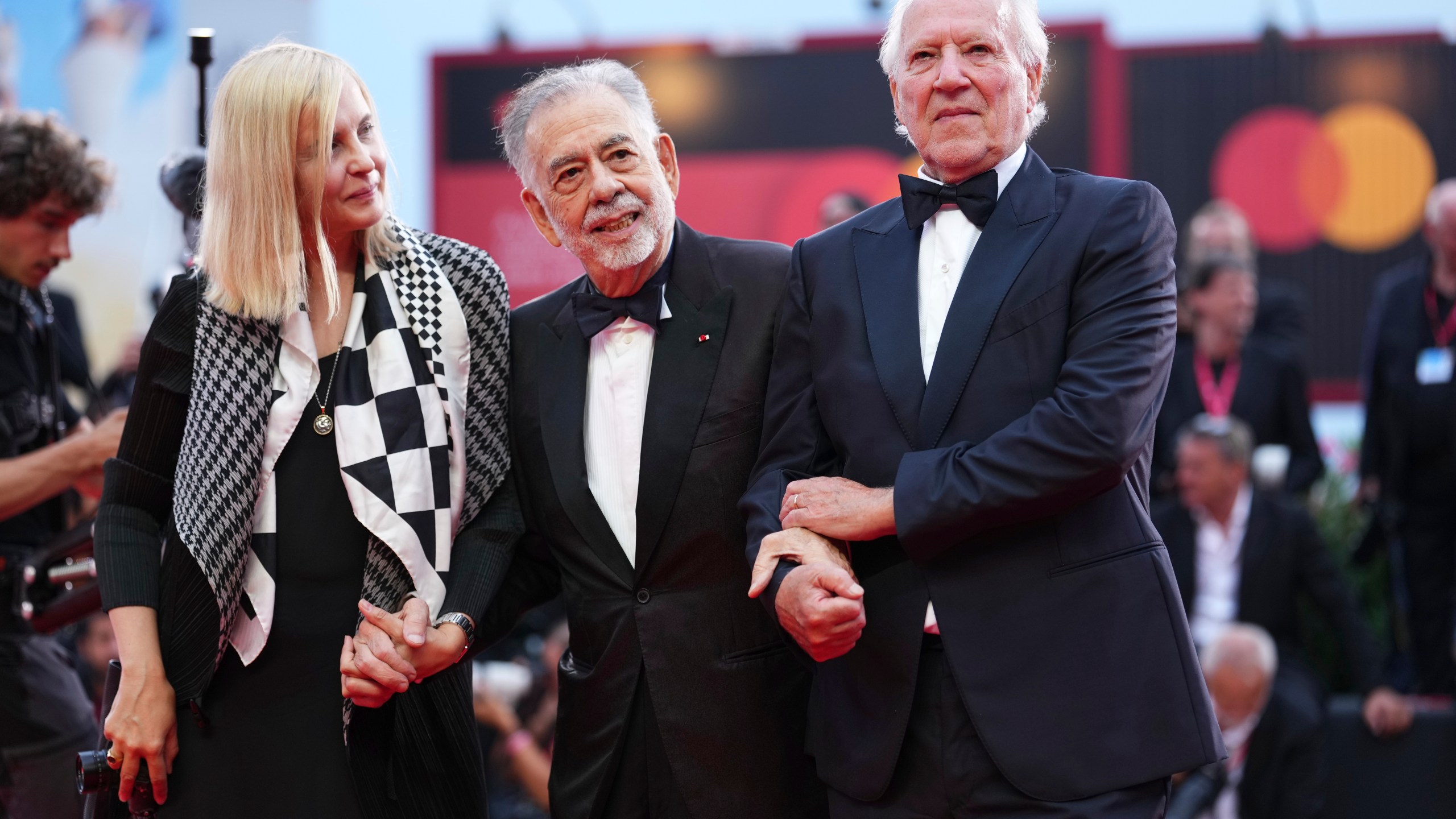 Lena Herzog, from left, Francis Ford Coppola, and Werner Herzog pose for photographers on the red carpet for the opening ceremony and the premiere of the film 'La Grazia' during the 82nd edition of the Venice Film Festival in Venice, Italy, on Wednesday, Aug. 27, 2025. (Photo by Scott A Garfitt/Invision/AP)